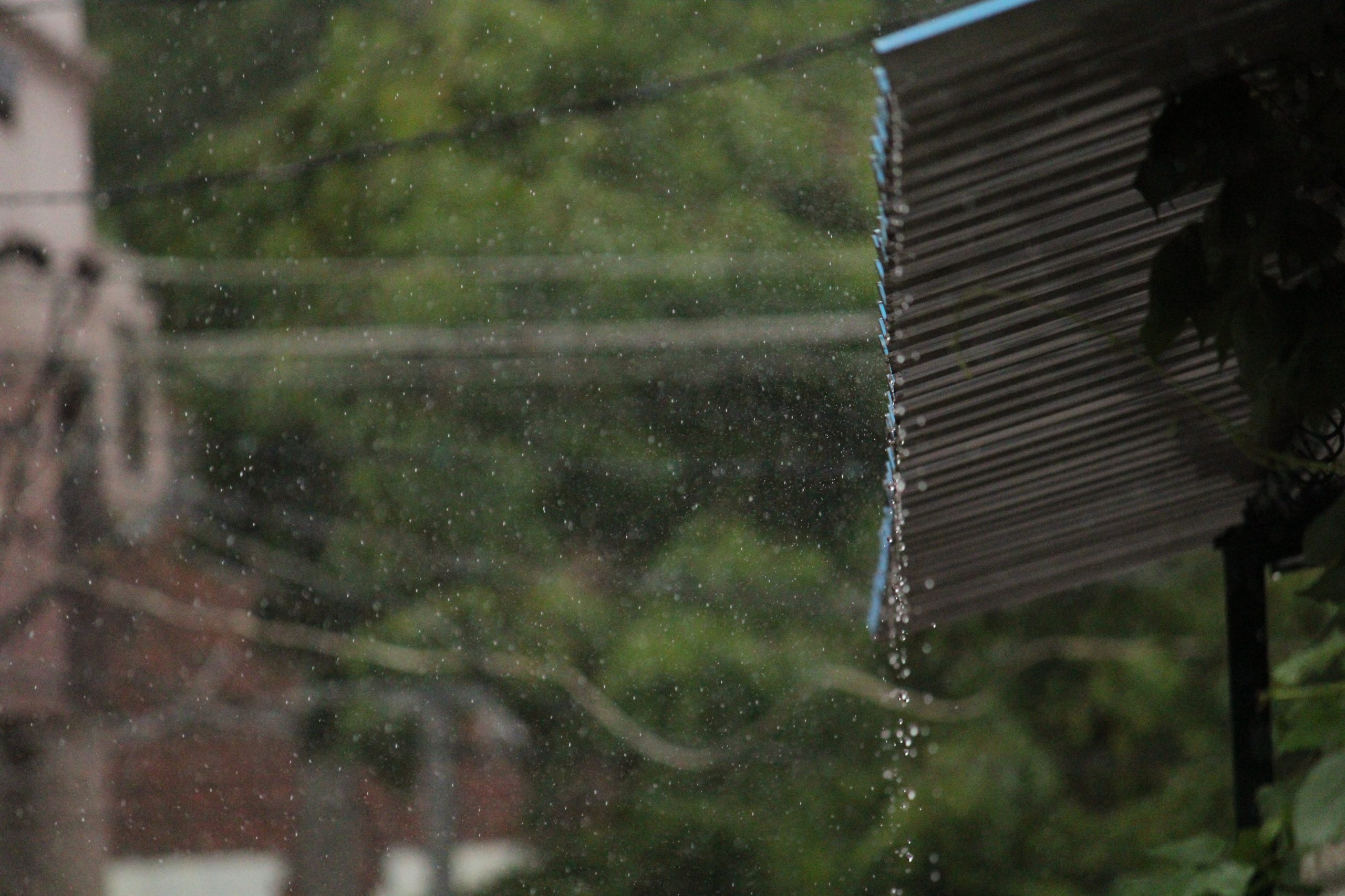 Rain water dripping off shed roof