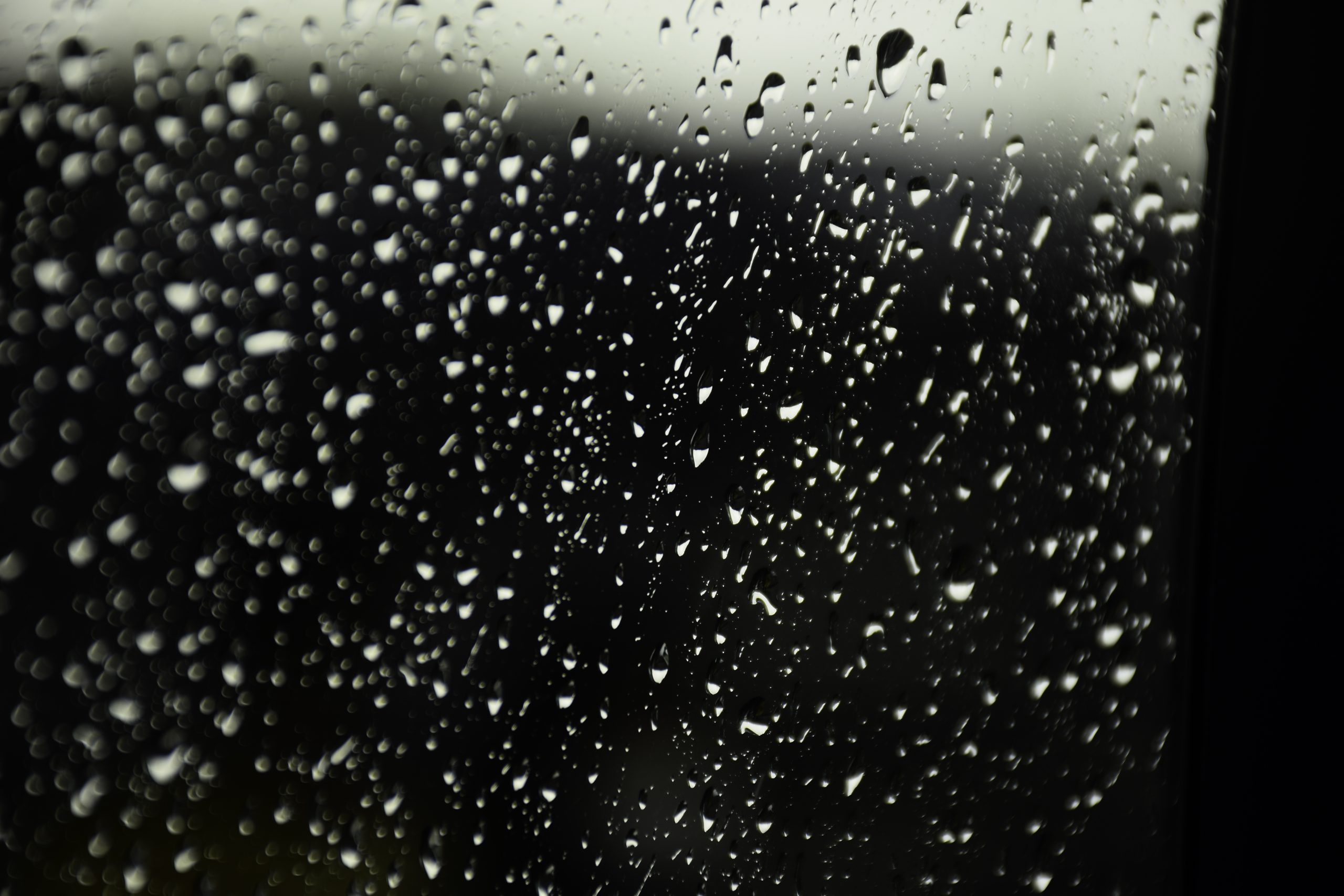 Car's window mirror during rain