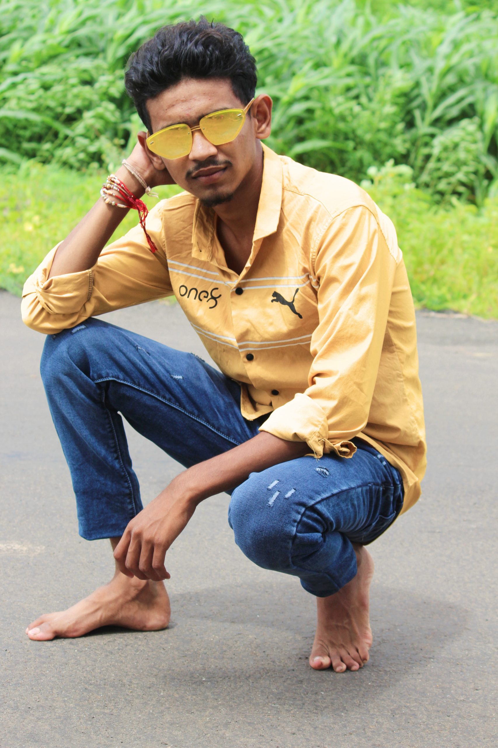 A boy sitting on a road