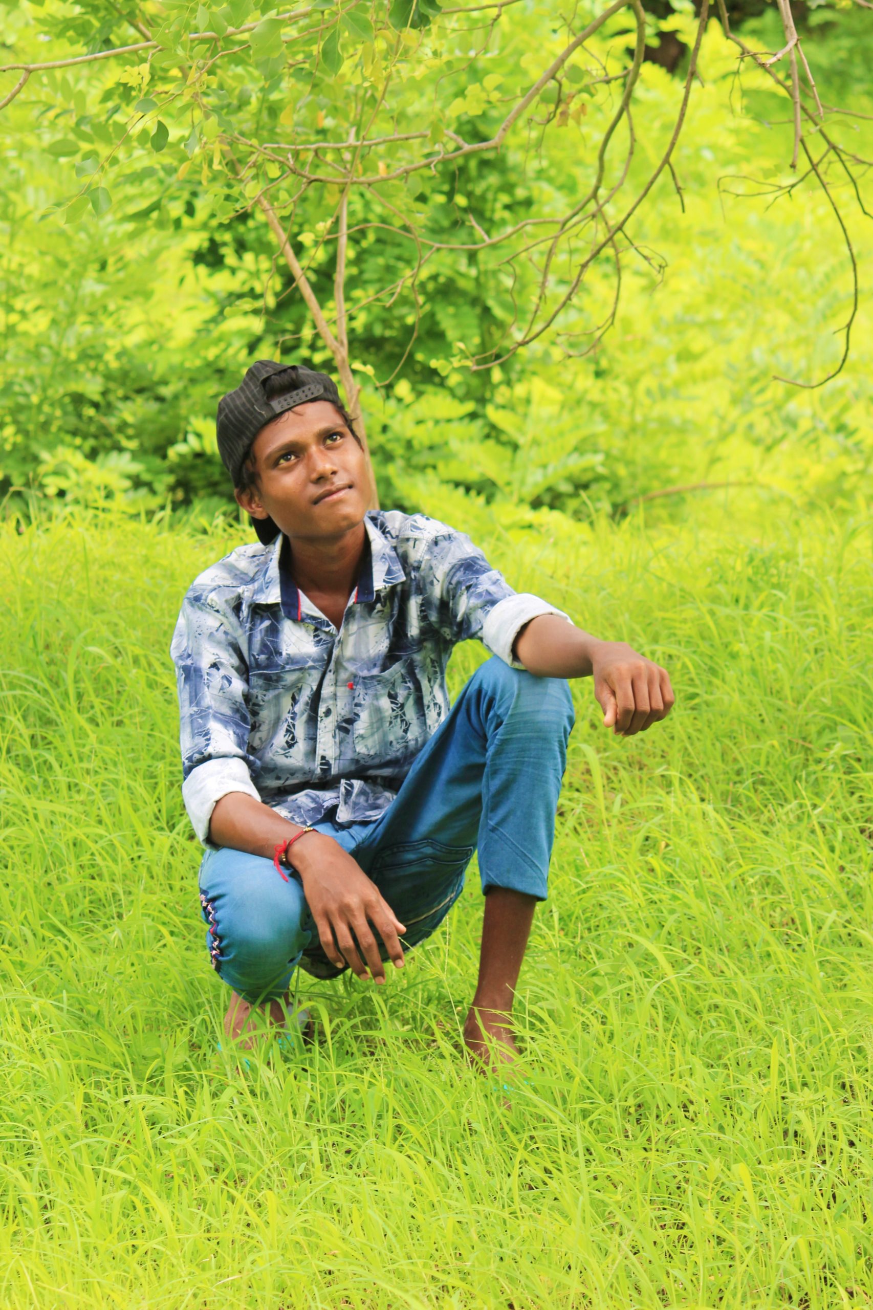 A boy sitting on grass