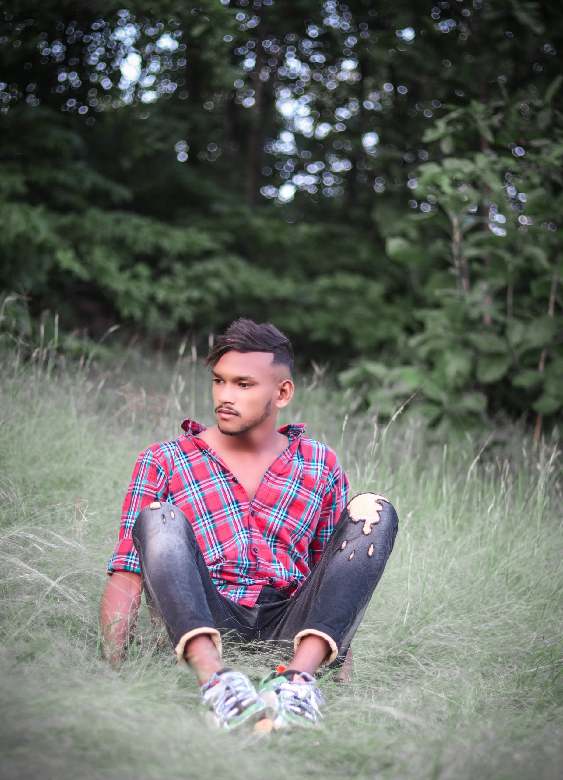 A boy sitting on grass