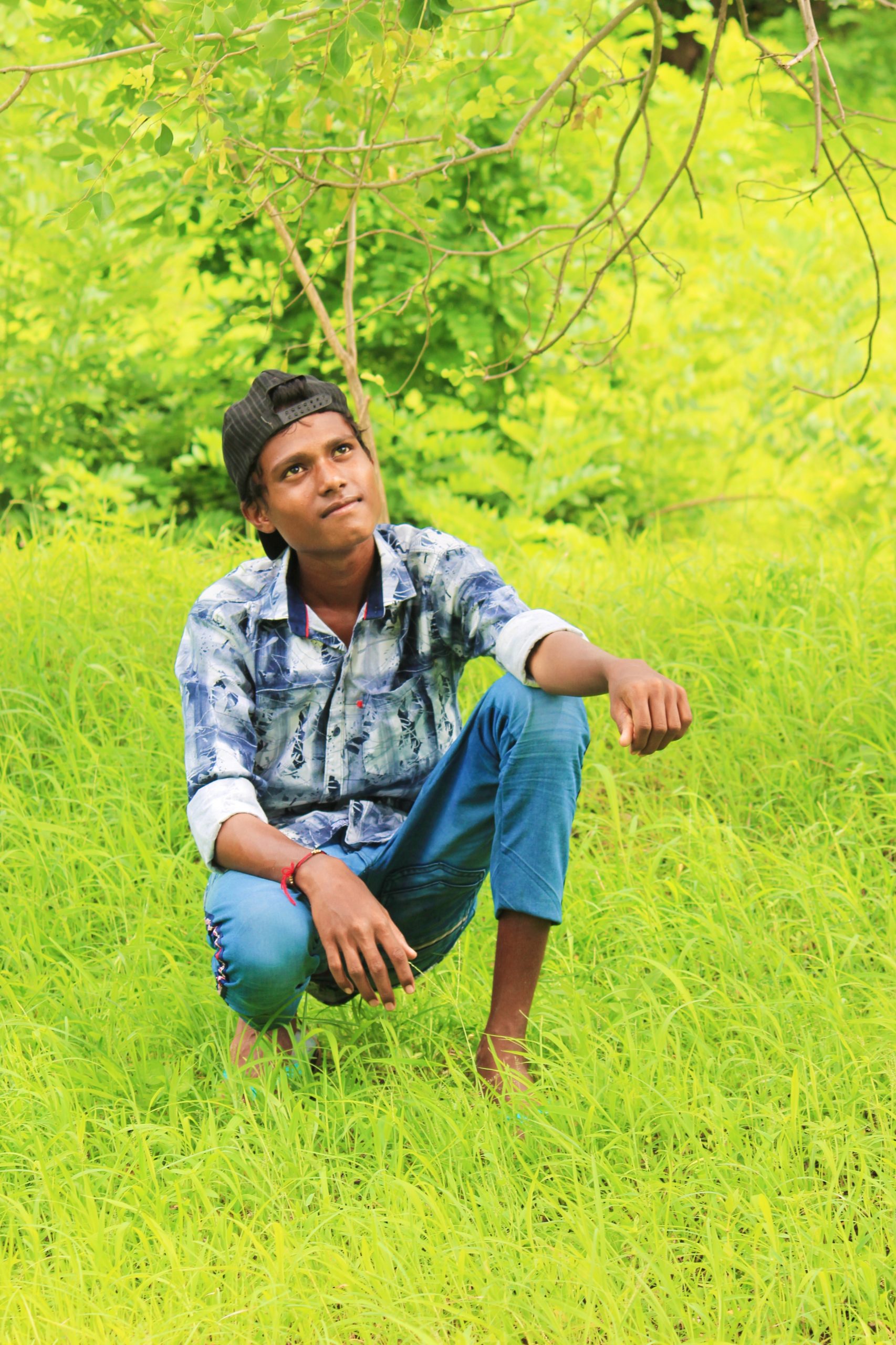 A boy sitting on green grass