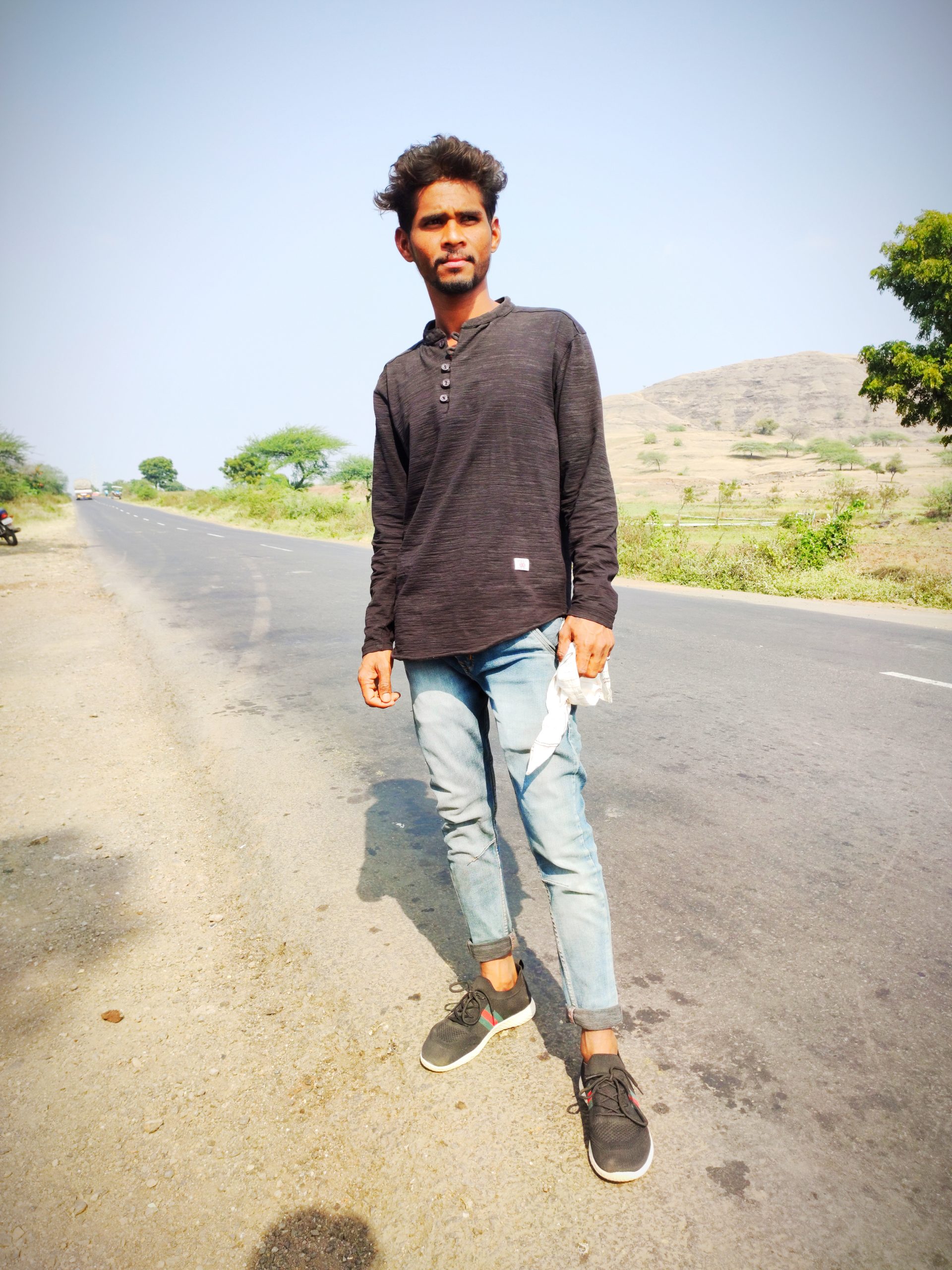 A boy standing on a road