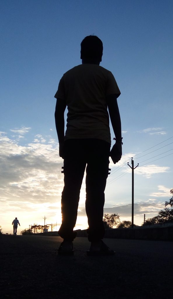 A boy standing on a road - PixaHive