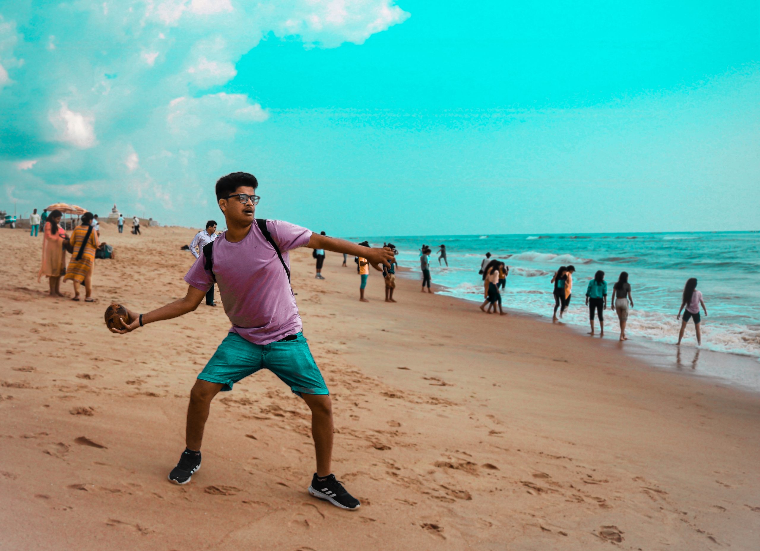 A boy throwing stone at a beach
