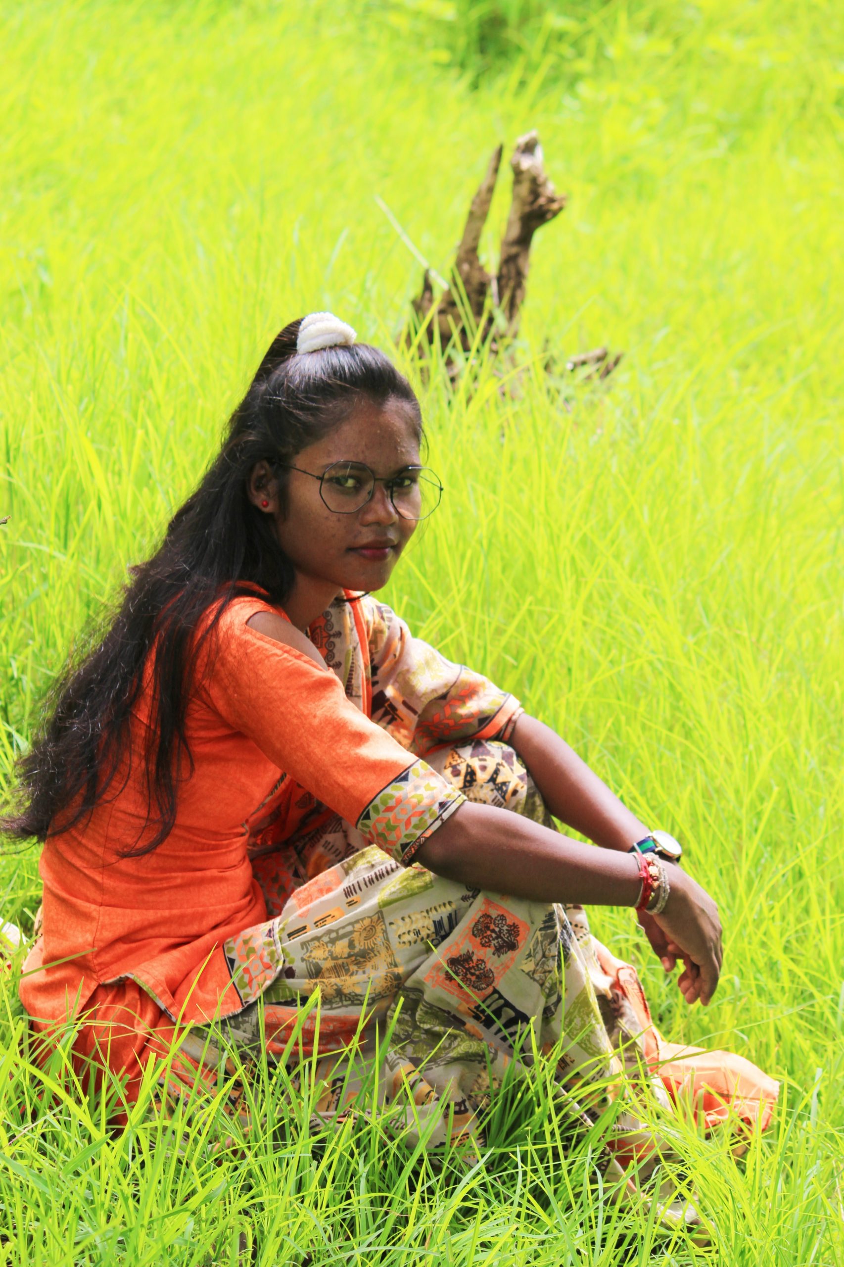 A girl sitting on grass