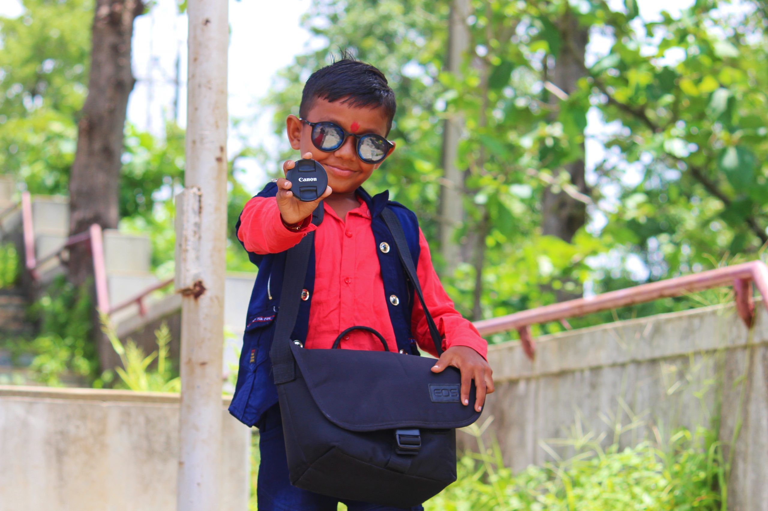 A little boy with lens cap