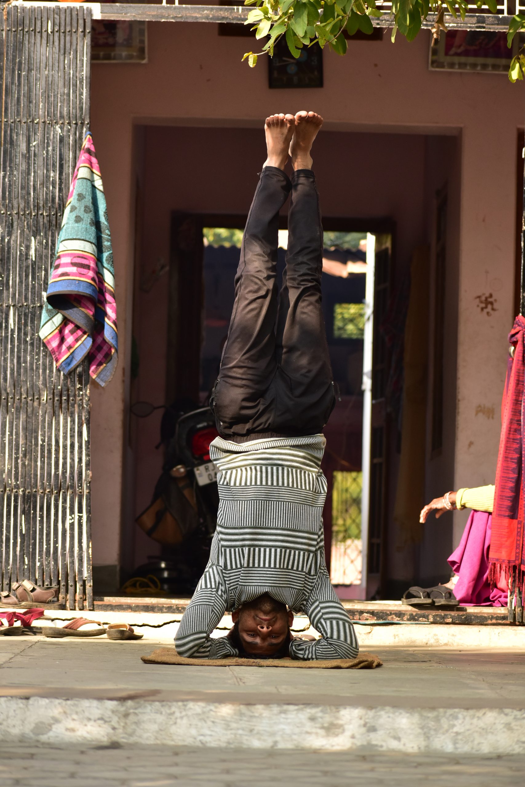 A man practicing head stand Yoga pose