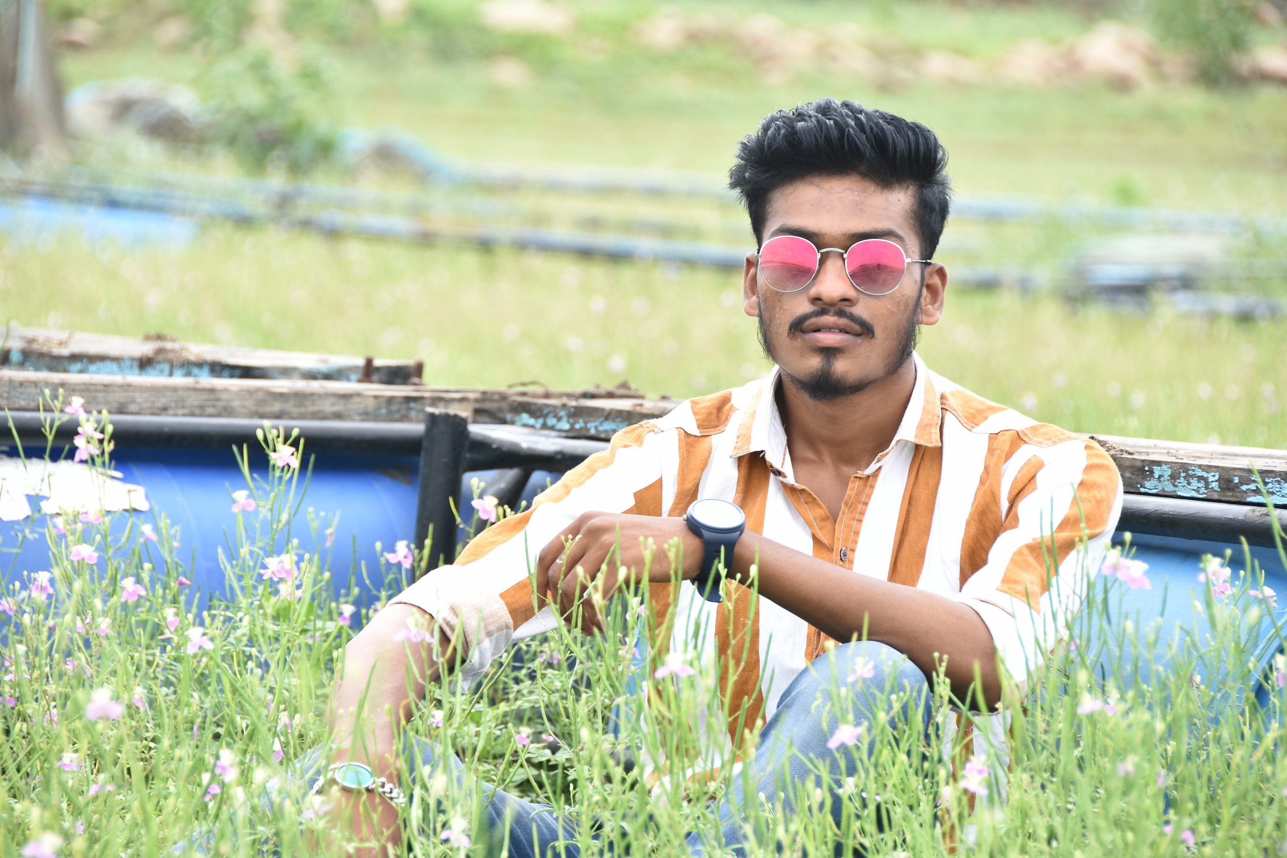 Boy in farm and posing with sunglasses