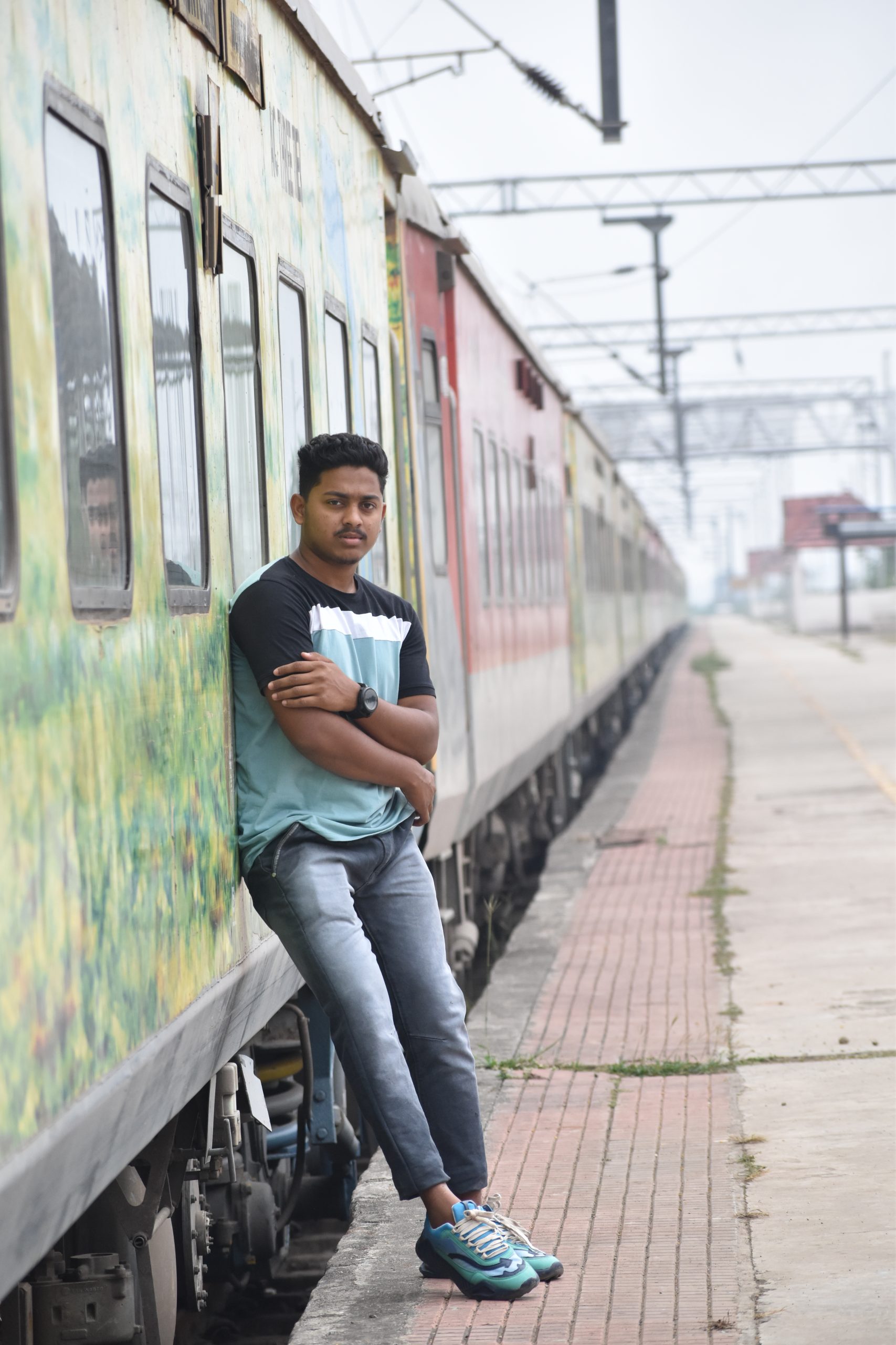 Boy posing against the train