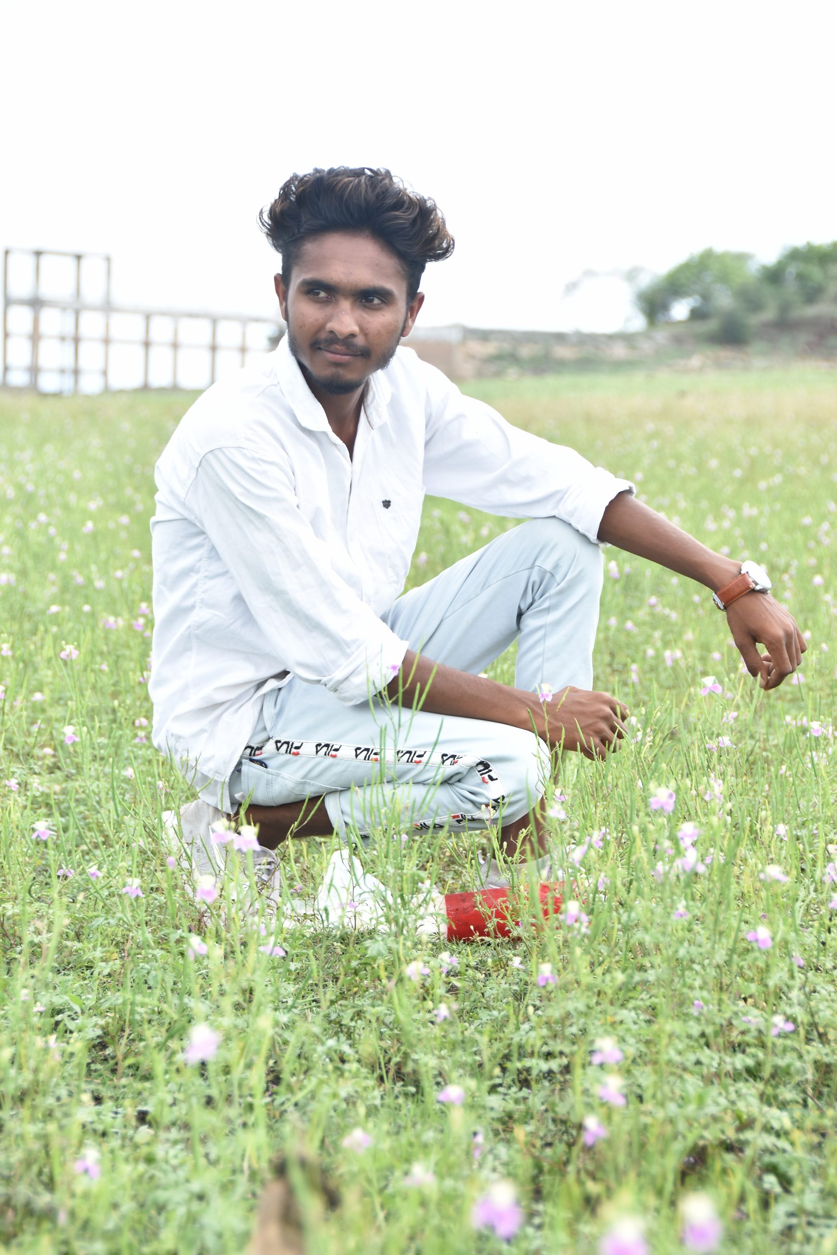 Boy posing in the grassy farm