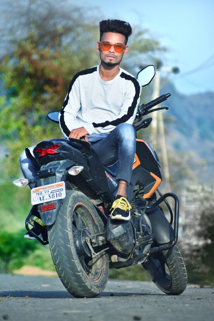 Premium Photo | Fashionable male motorcycle driver poses on black motorbike,  wears protective sunglasses