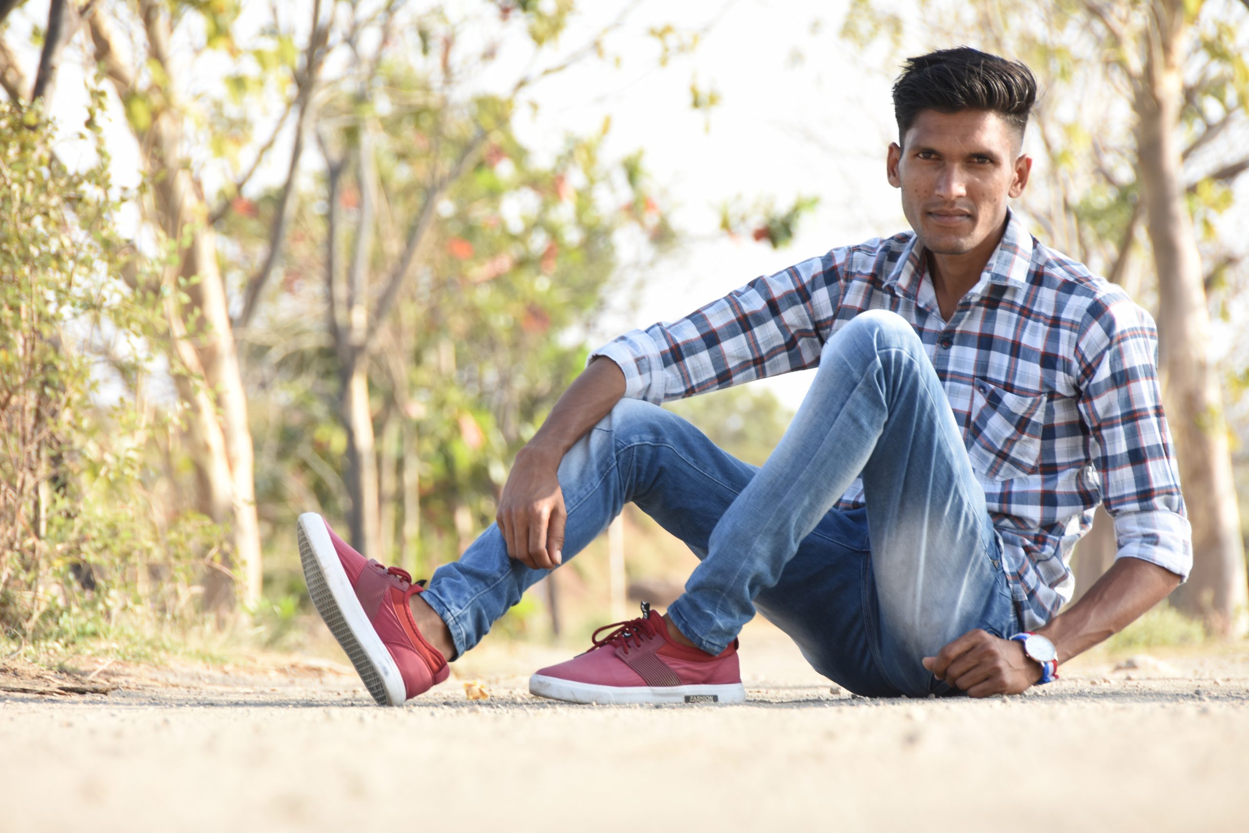 Boy posing while sitting on the road