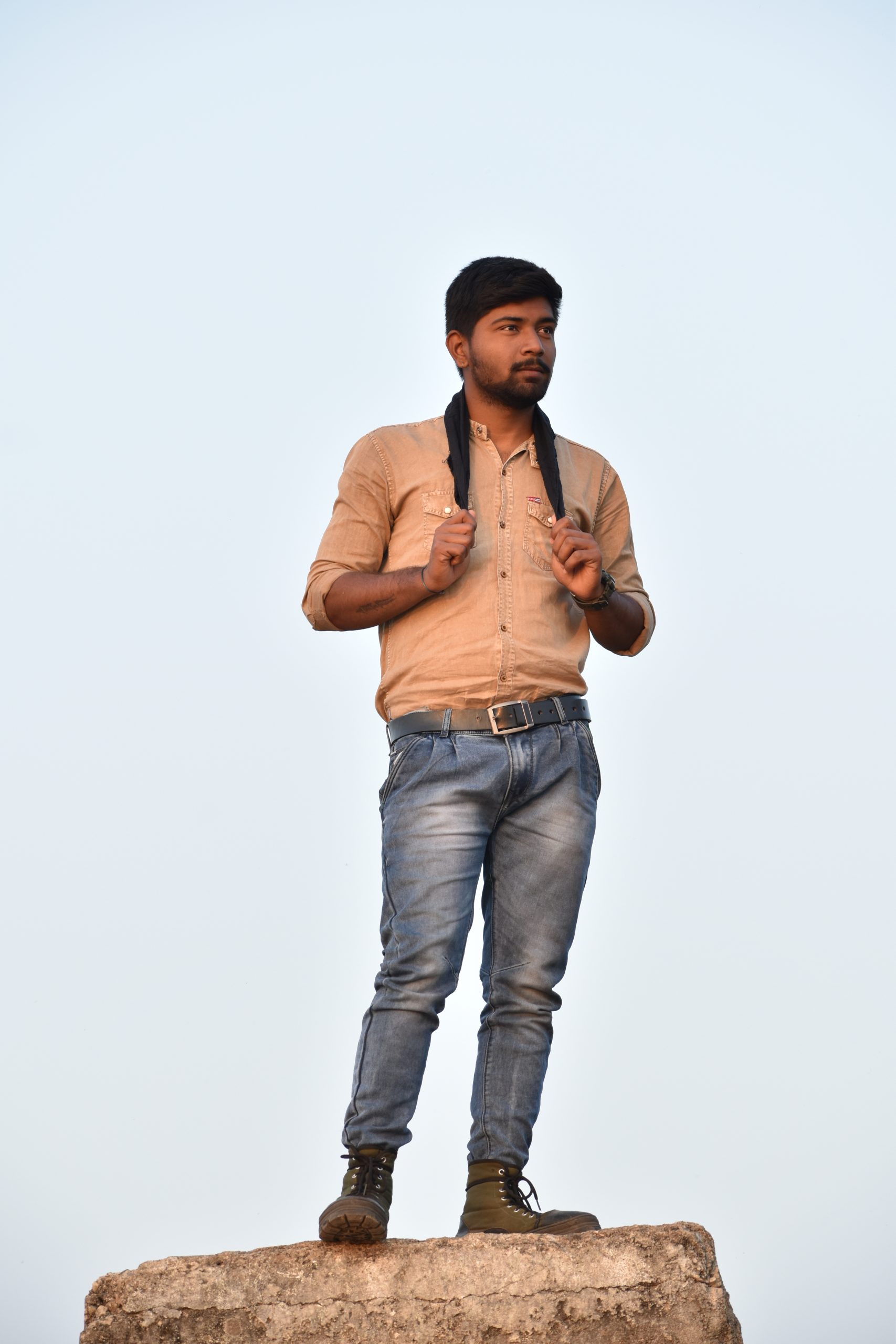 Boy with hanky posing on rock