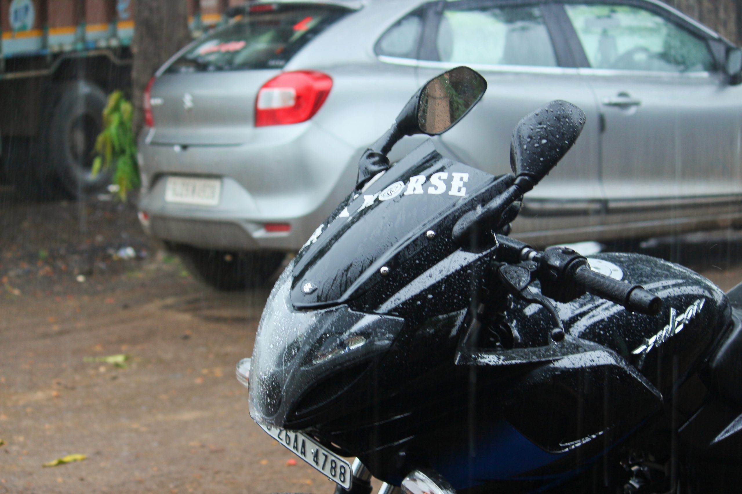 Car and bike in rain
