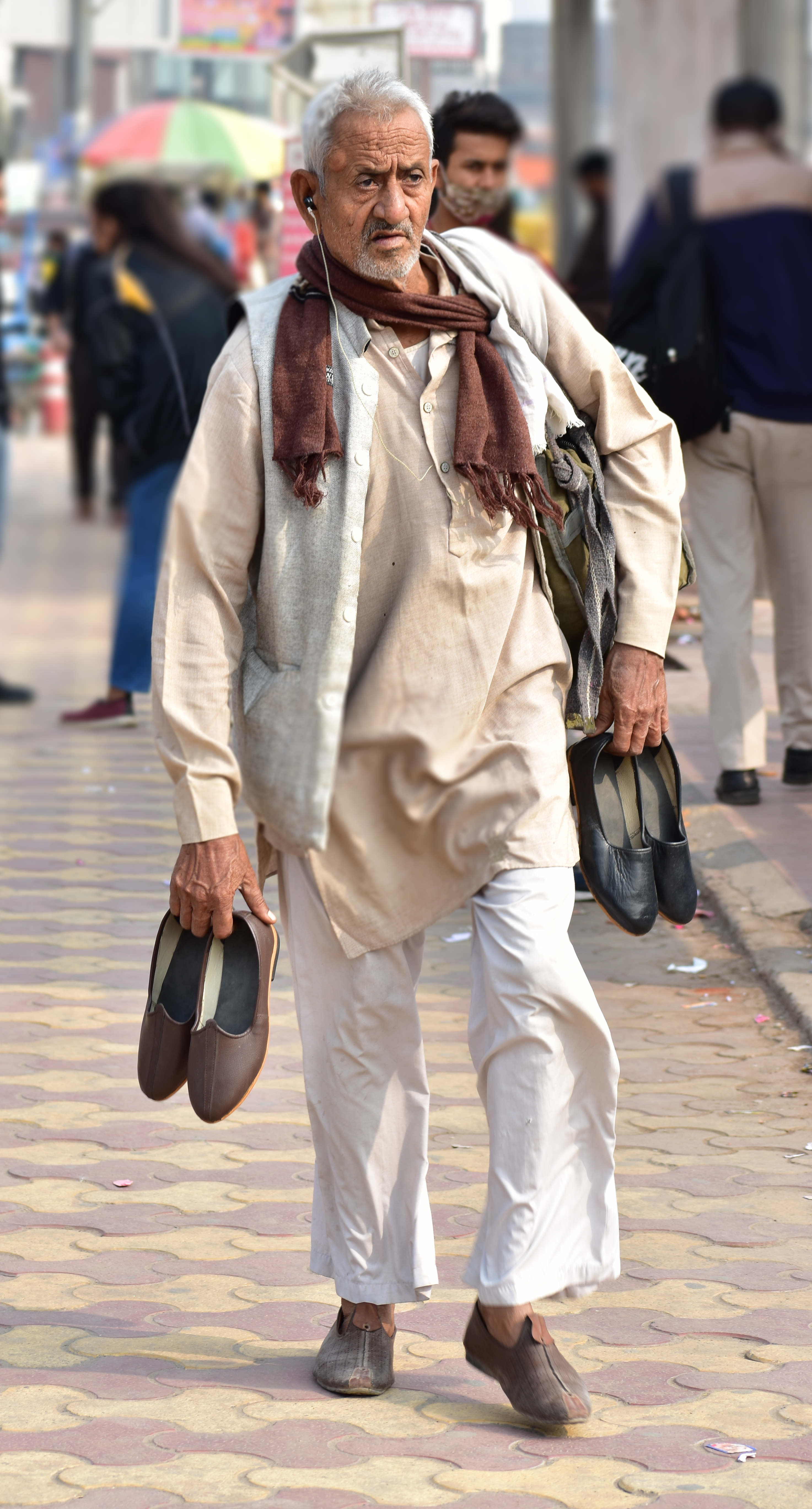 An Old guy selling leather shoes