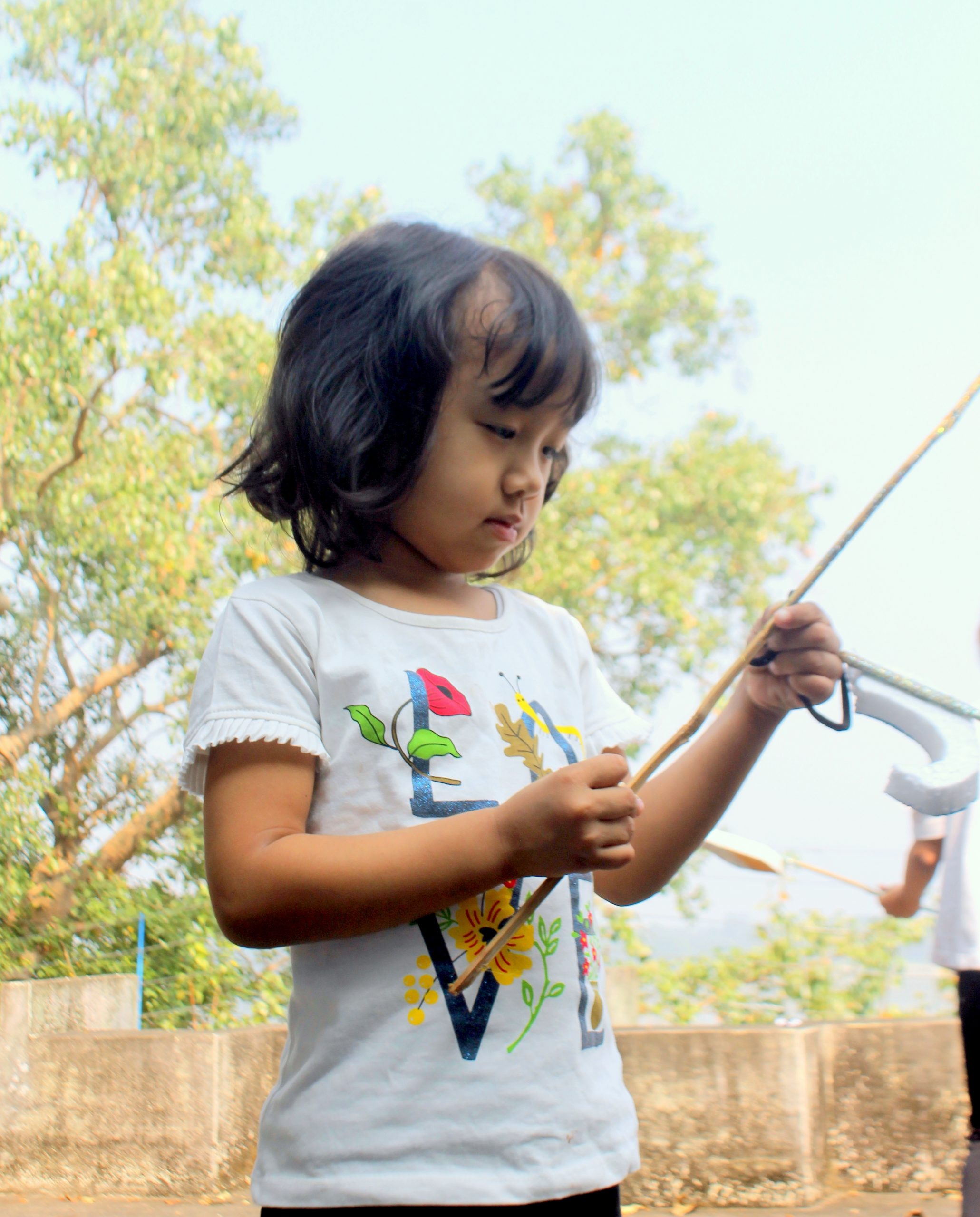 Girl with wood stick