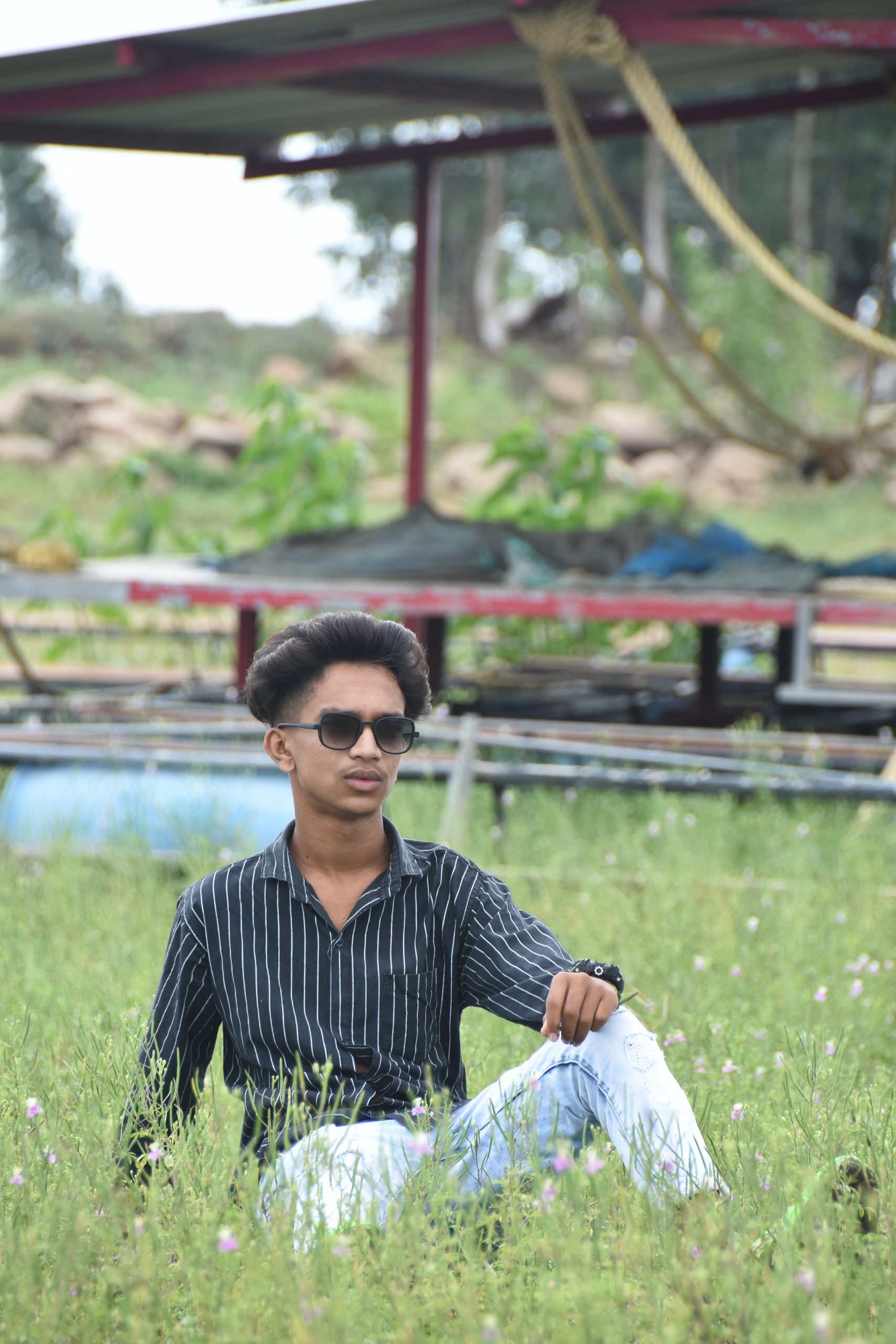Boy posing in the grassy farm
