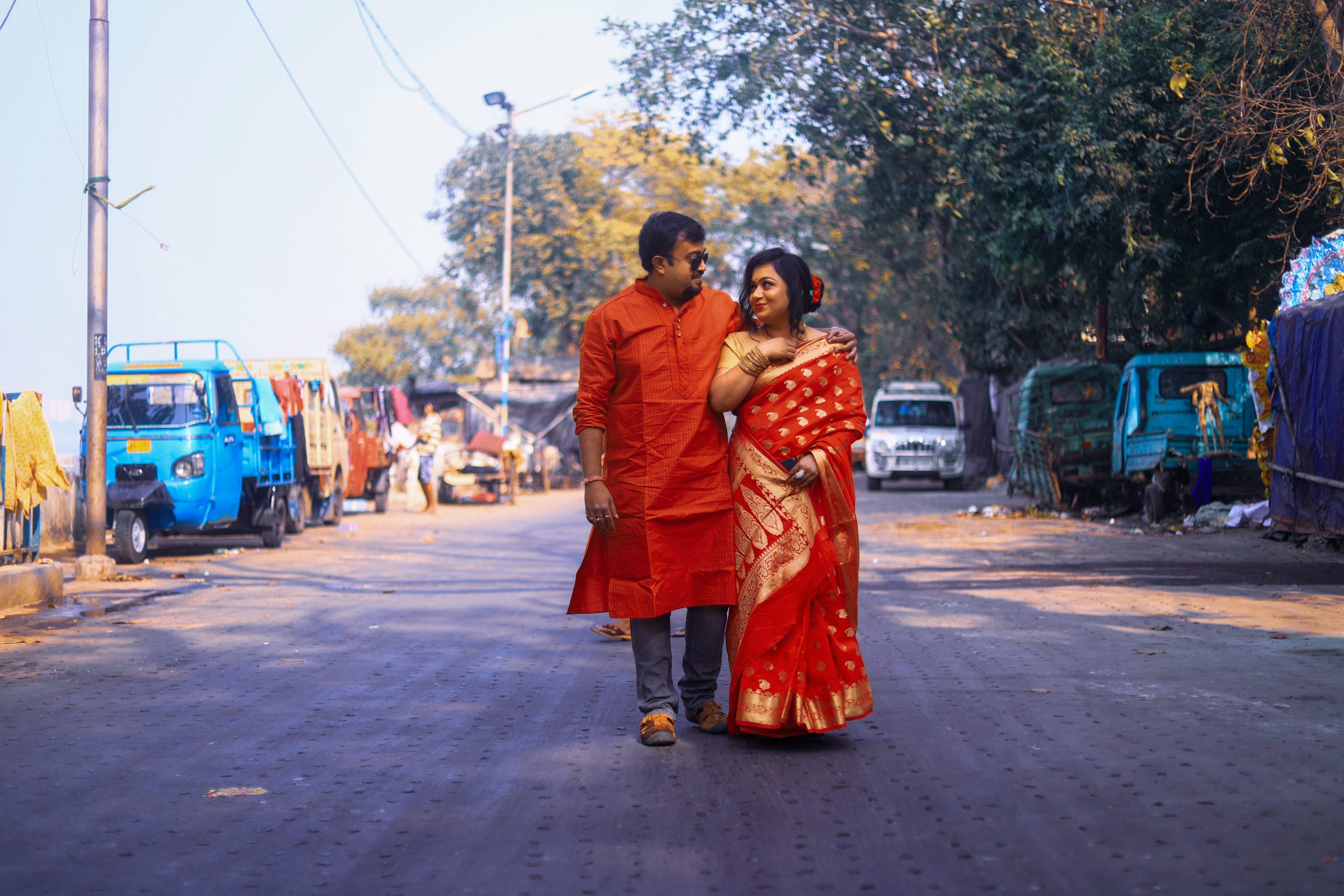 A married couple walking on a road