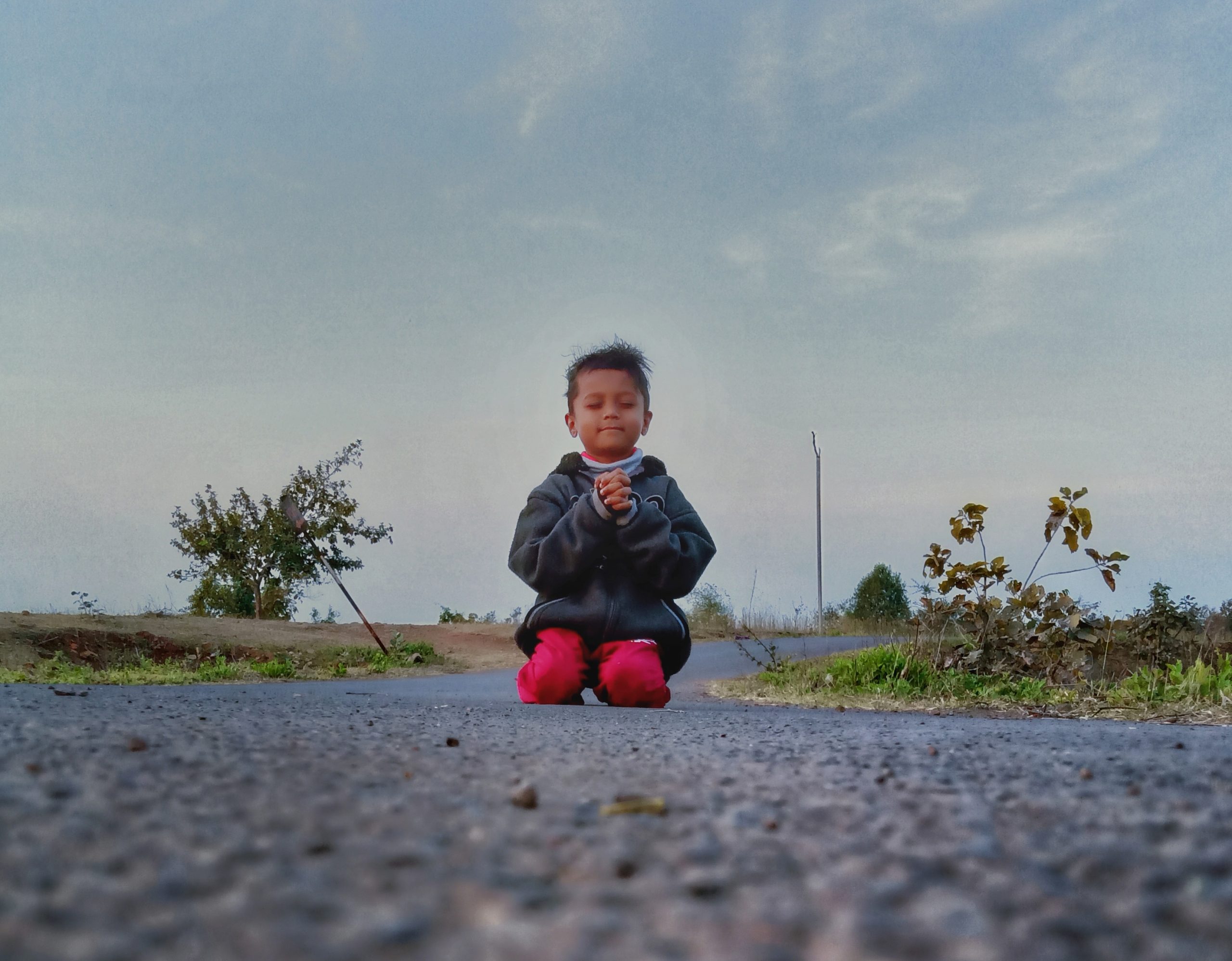 Kid Praying on the road