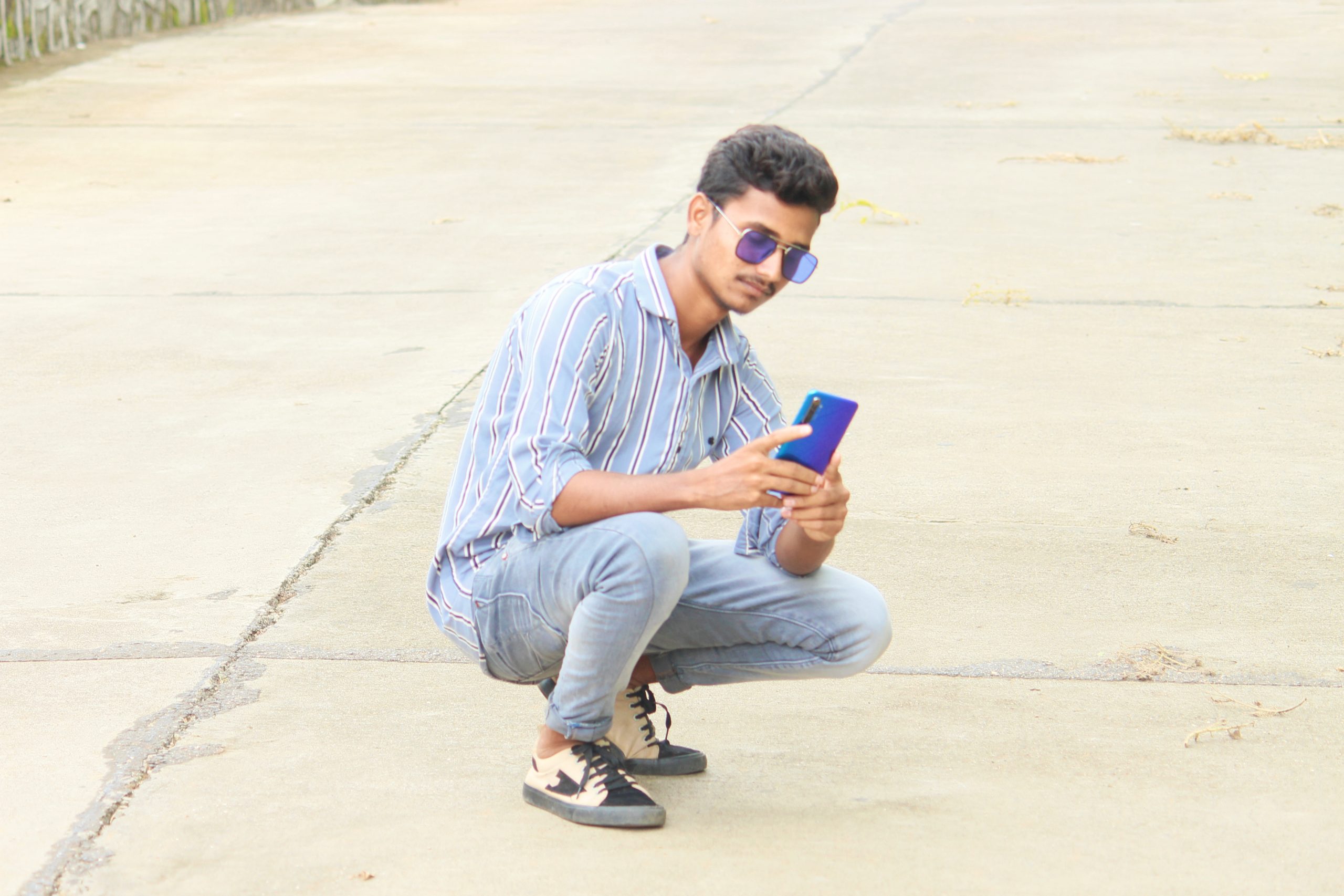 Male Model posing while mobile in his hand