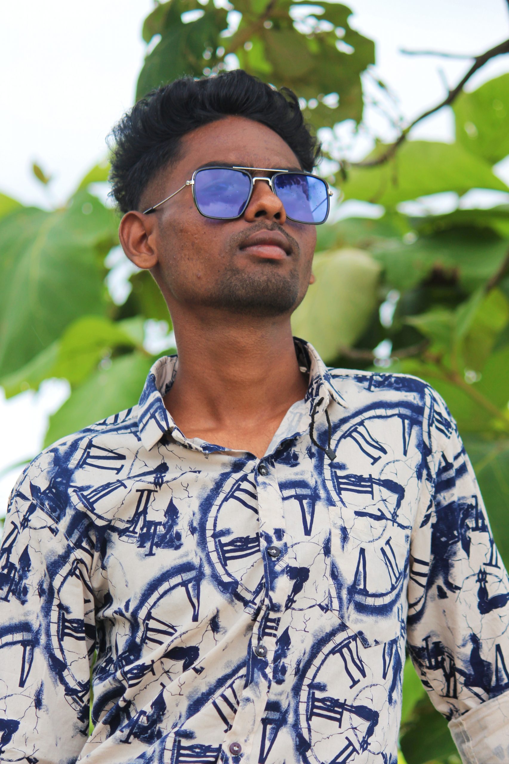 Model posing in the garden with sunglasses