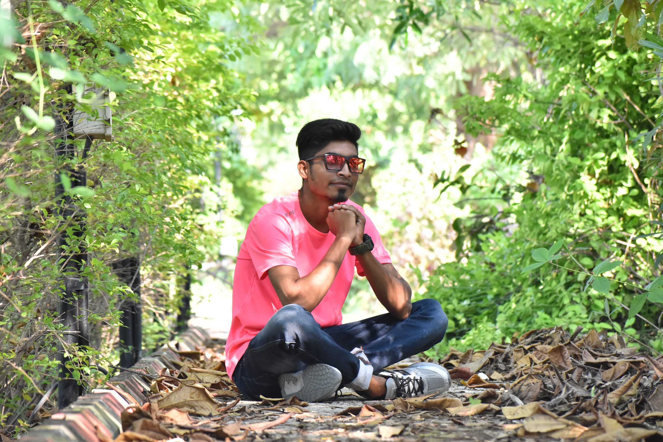 Boy sitting in the forest and posing