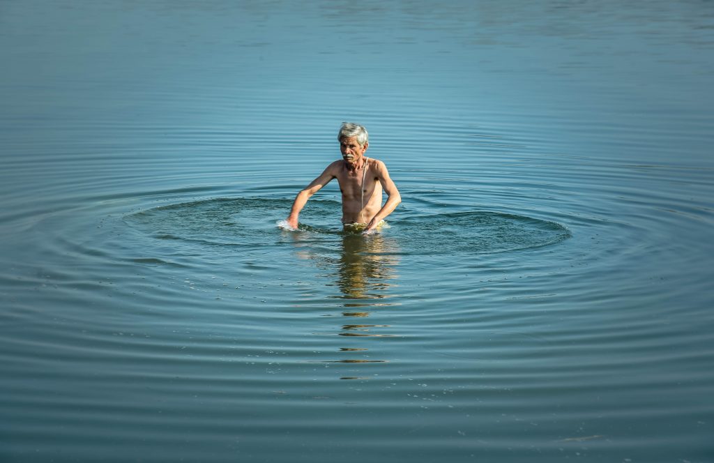 Old man bathing in the river PixaHive