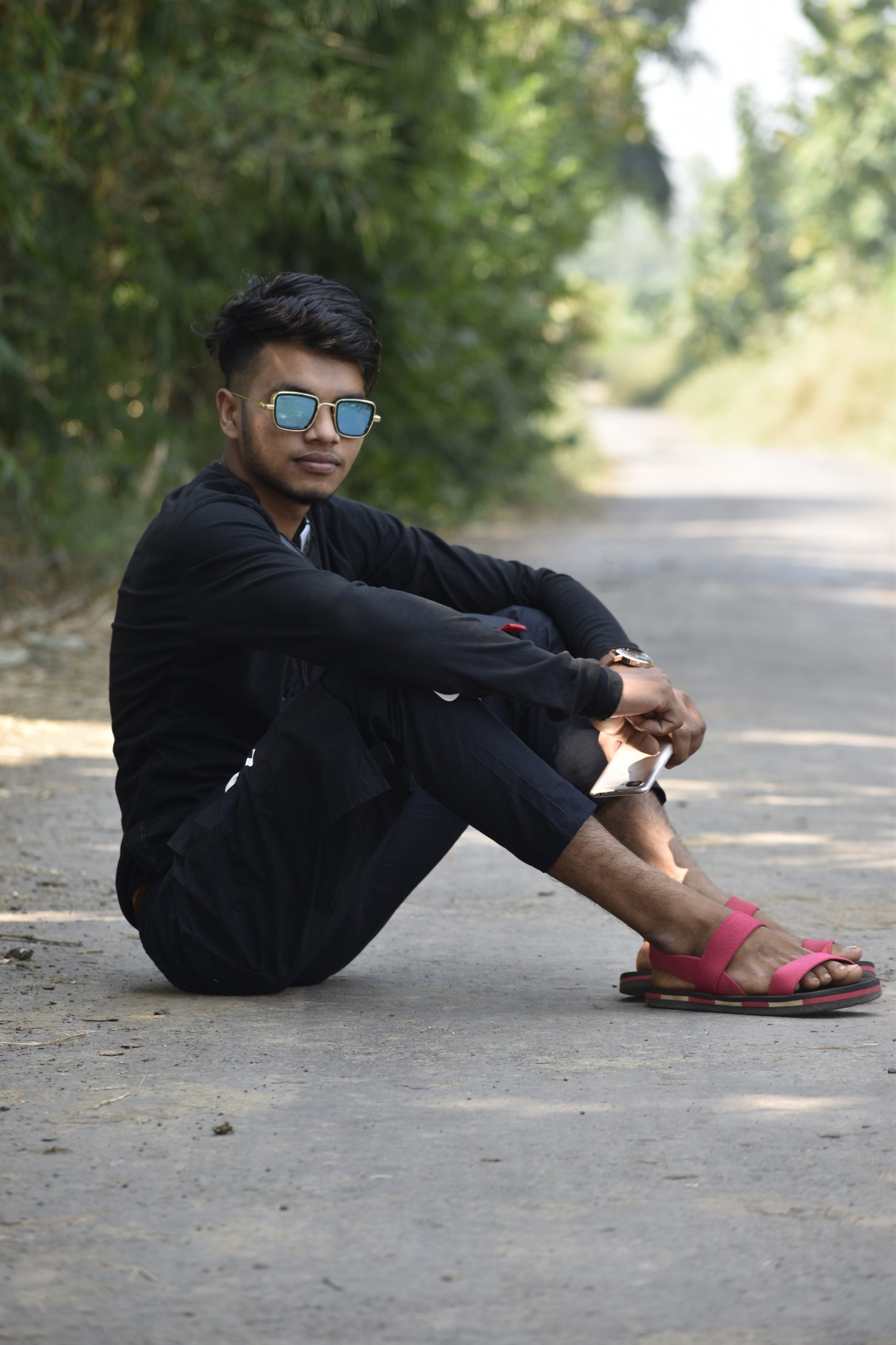 Boy posing on the road while sitting