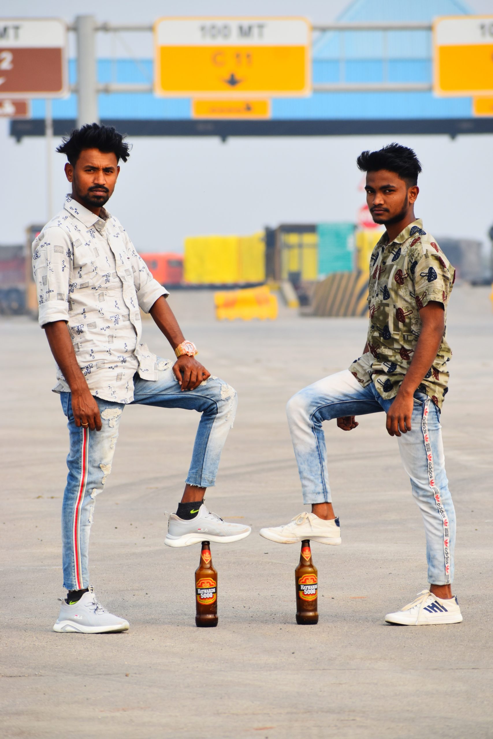 Two boys posing with Howards beer bottle