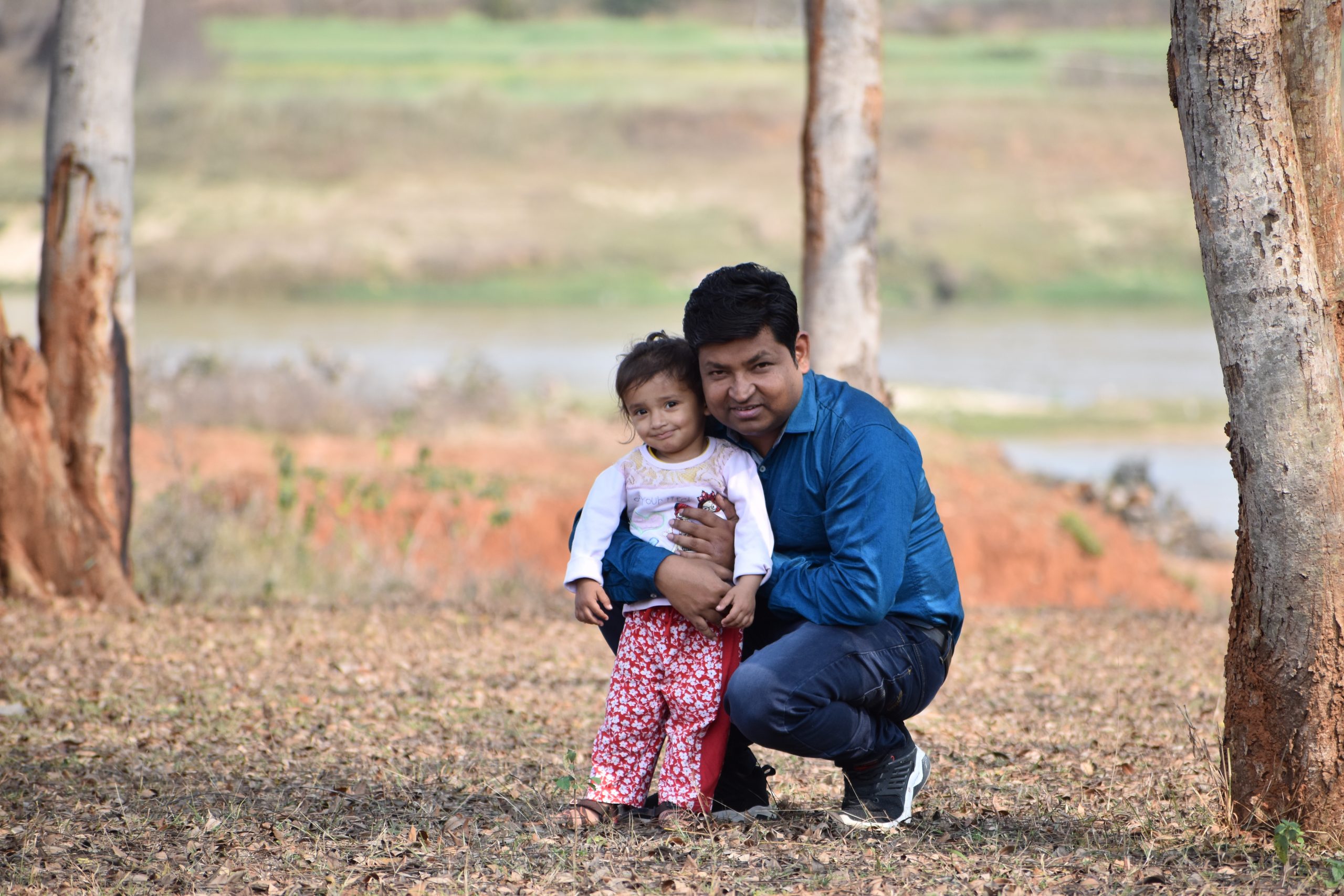 father and baby in the farm