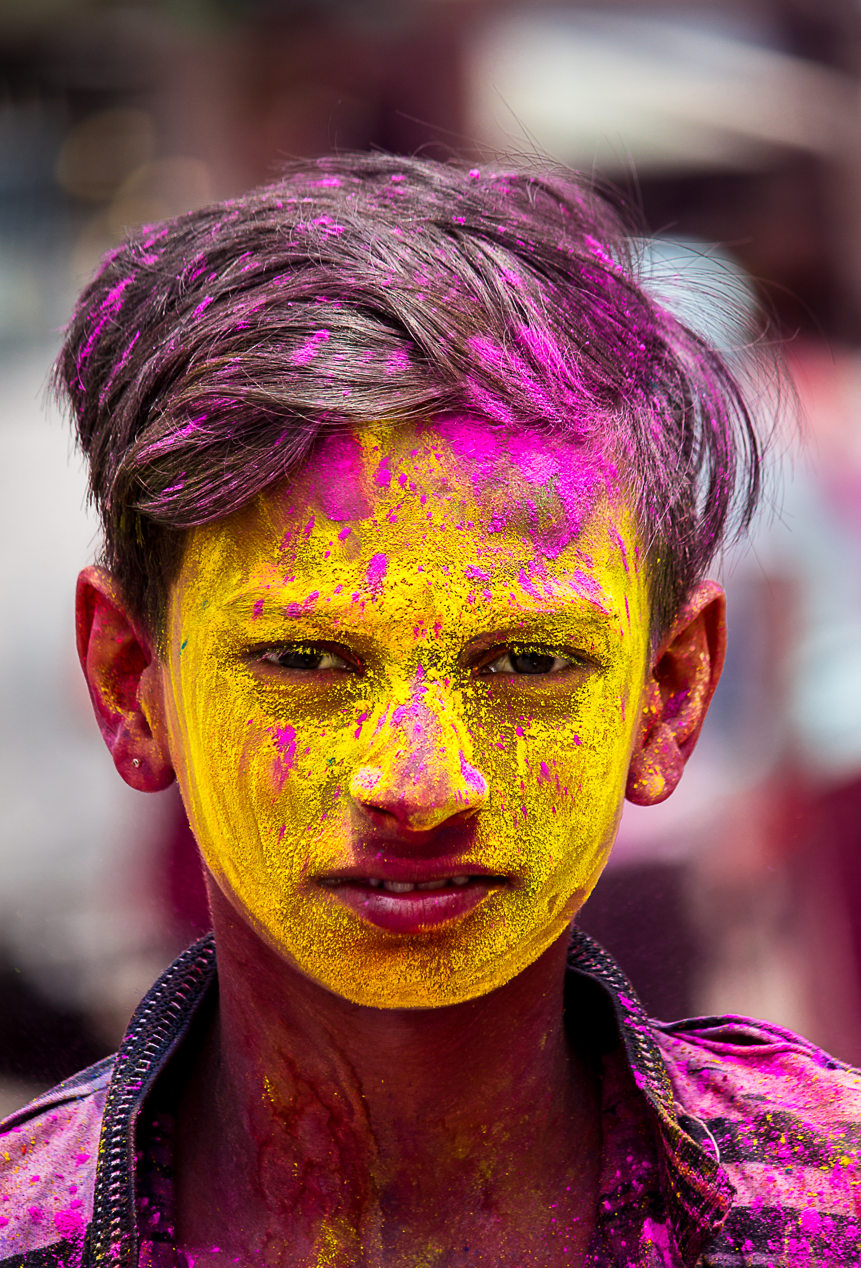 A boy's face painted with Holi colors