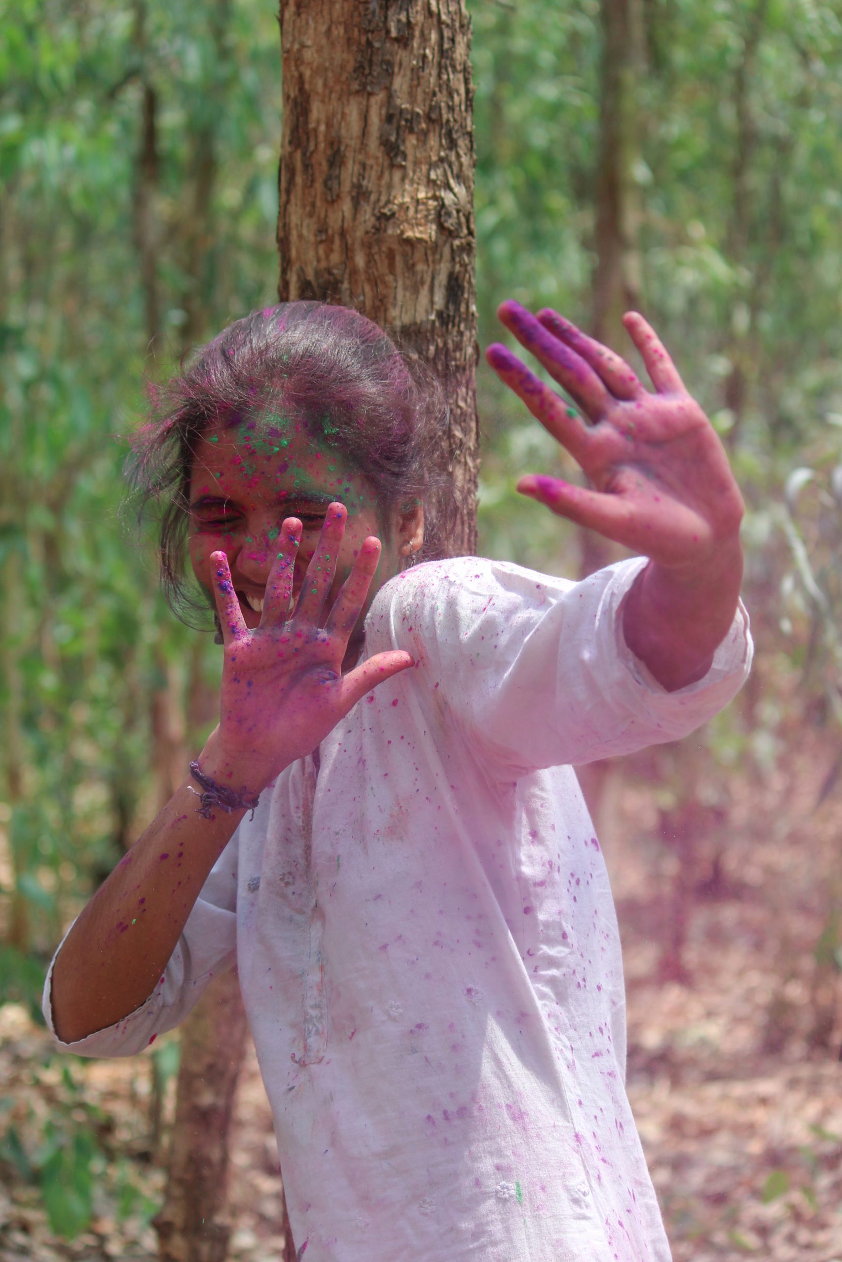 A girl playing with Holi colors