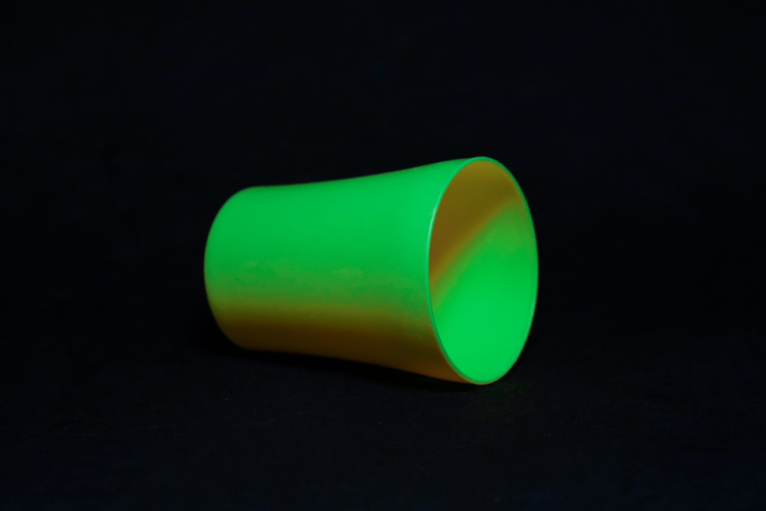 A green tumbler with black background