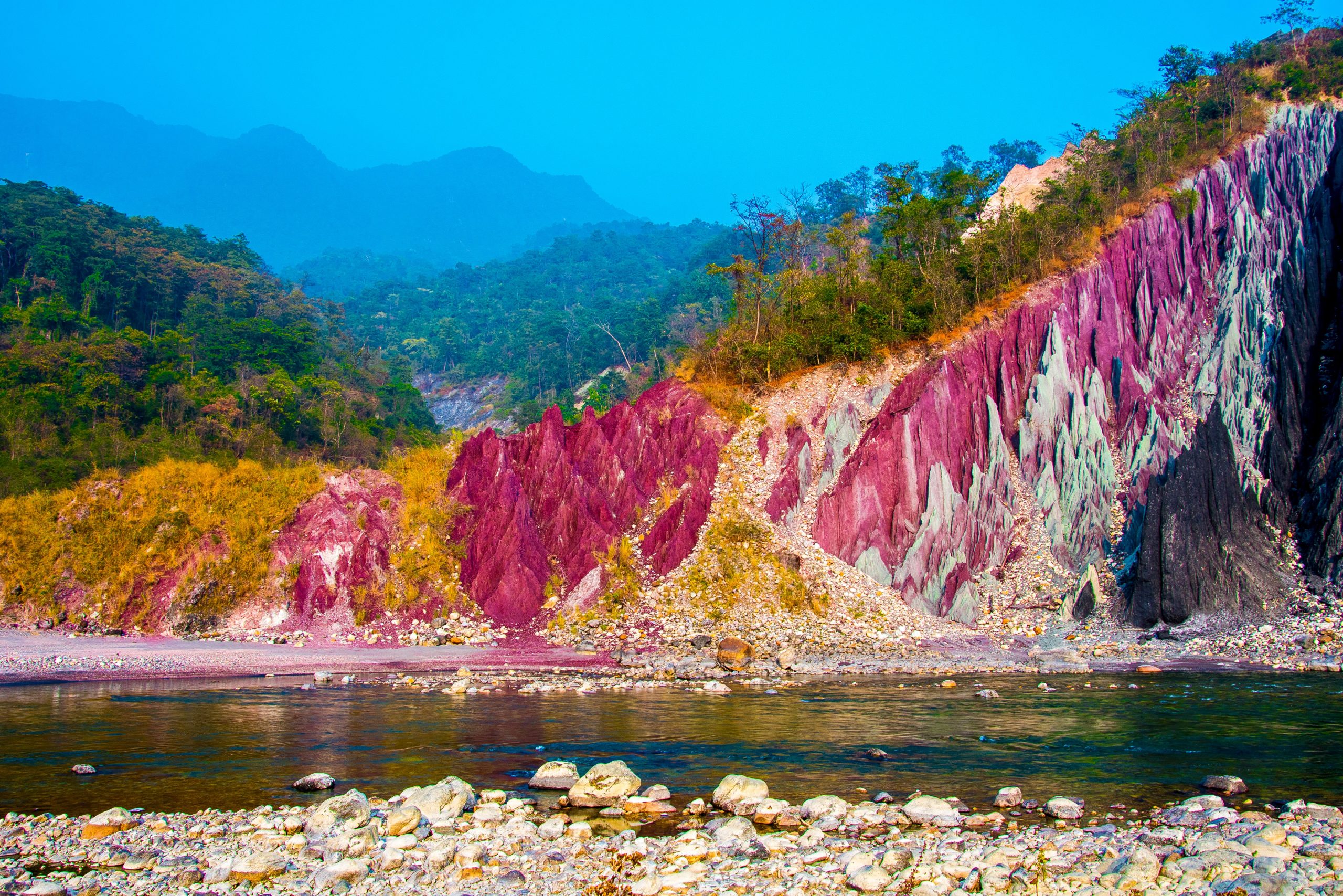 A river under colorful mountains