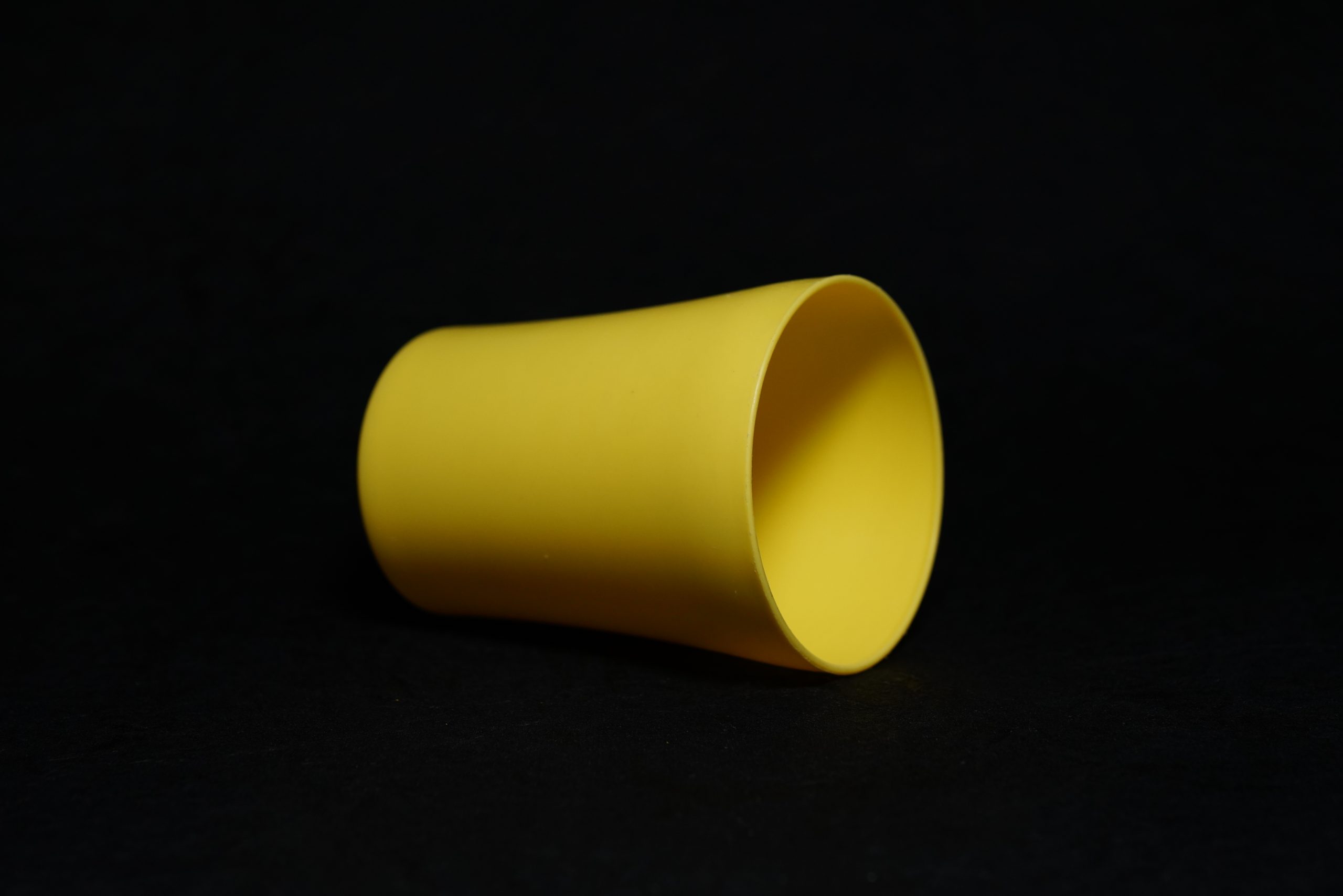 A yellow glass with black background