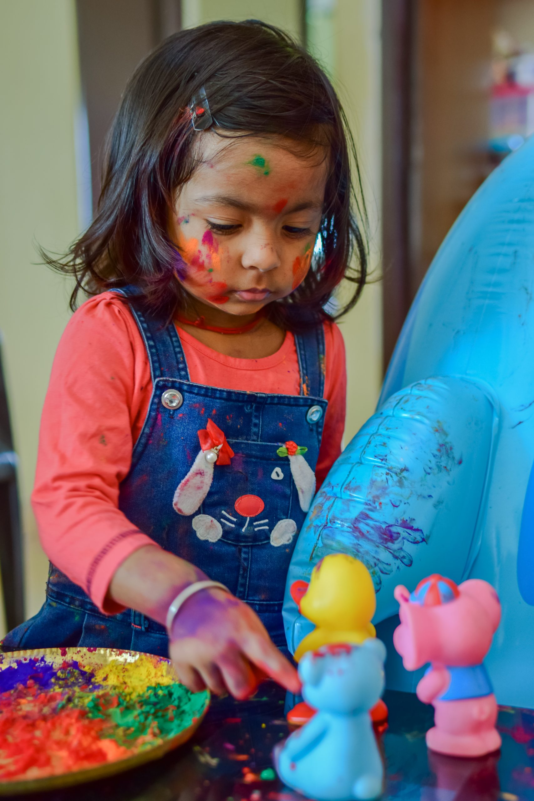 A little girl playing with holi colors