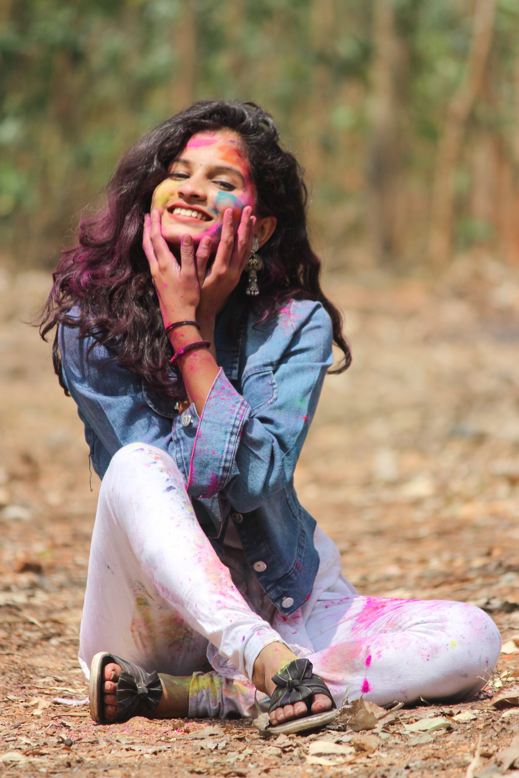 Beautiful female model posing with Holi colors