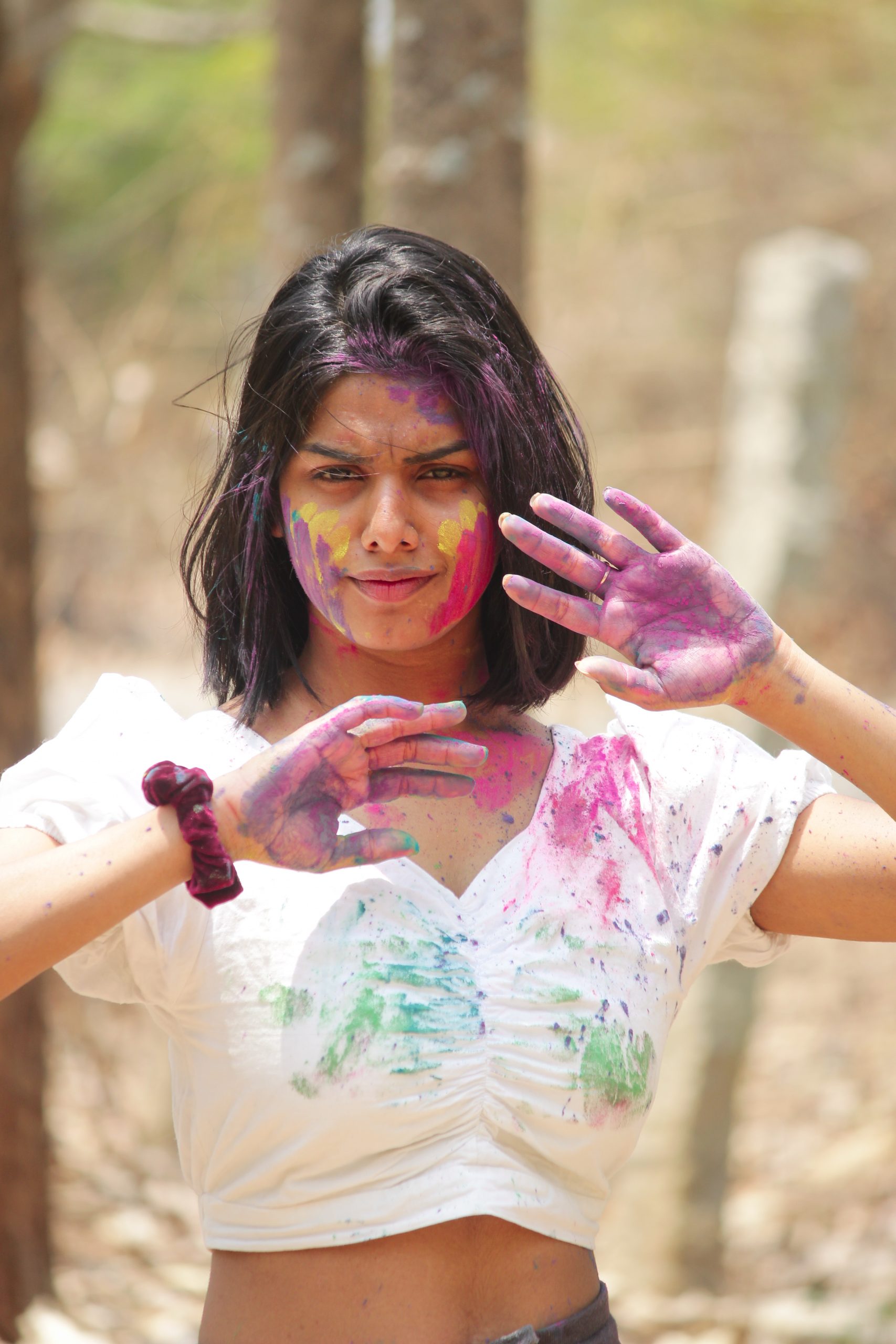 Beautiful girl playing with Holi colors