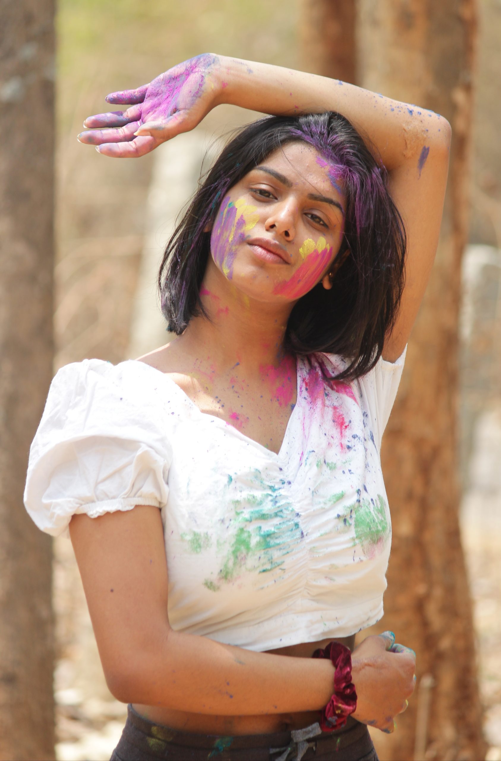 Beautiful girl posing with Holi colors