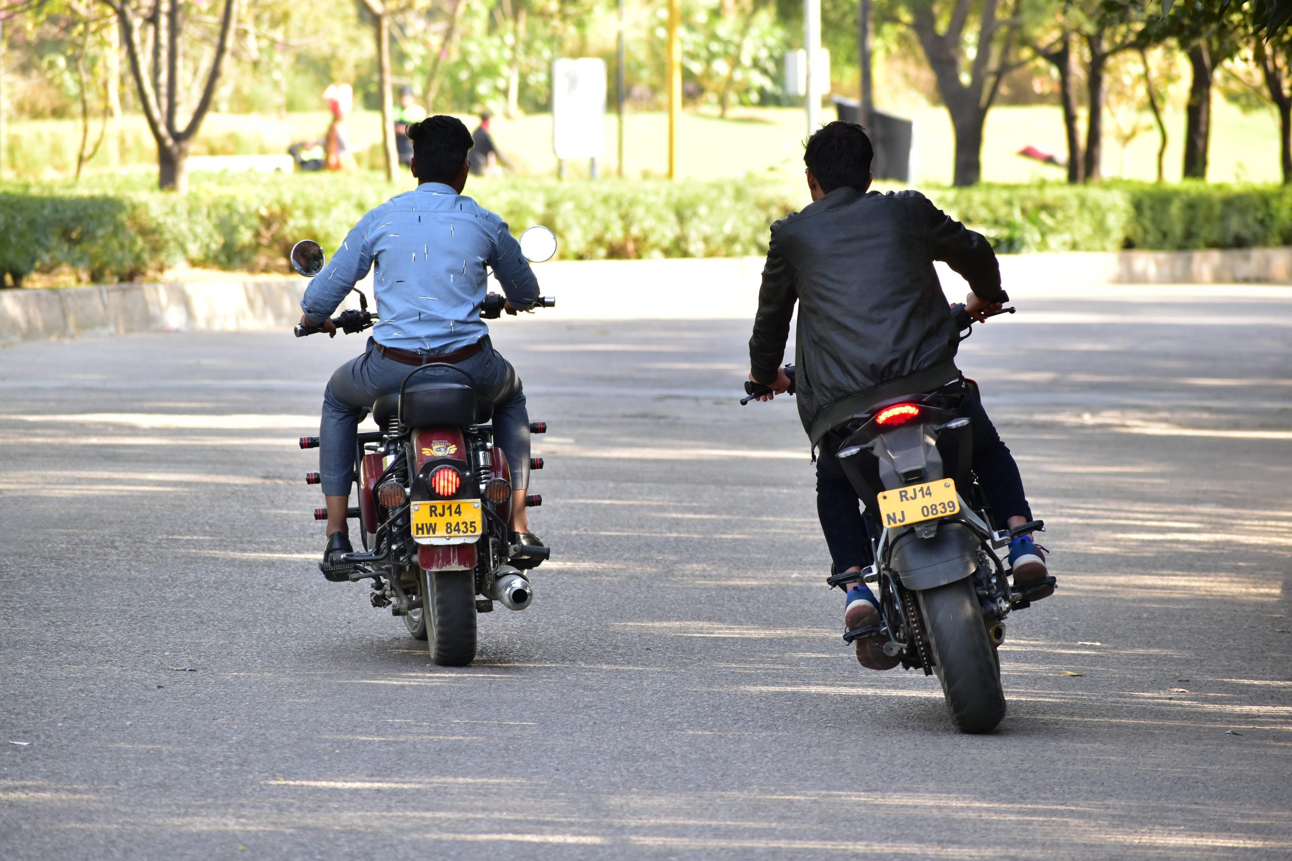 Boys driving bikes on a road