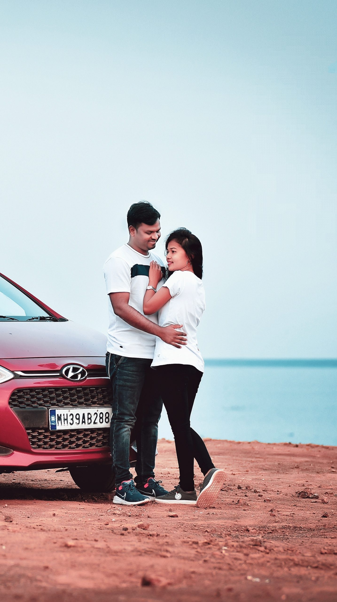 Casual couple posing near a car. Stock-Foto | Adobe Stock