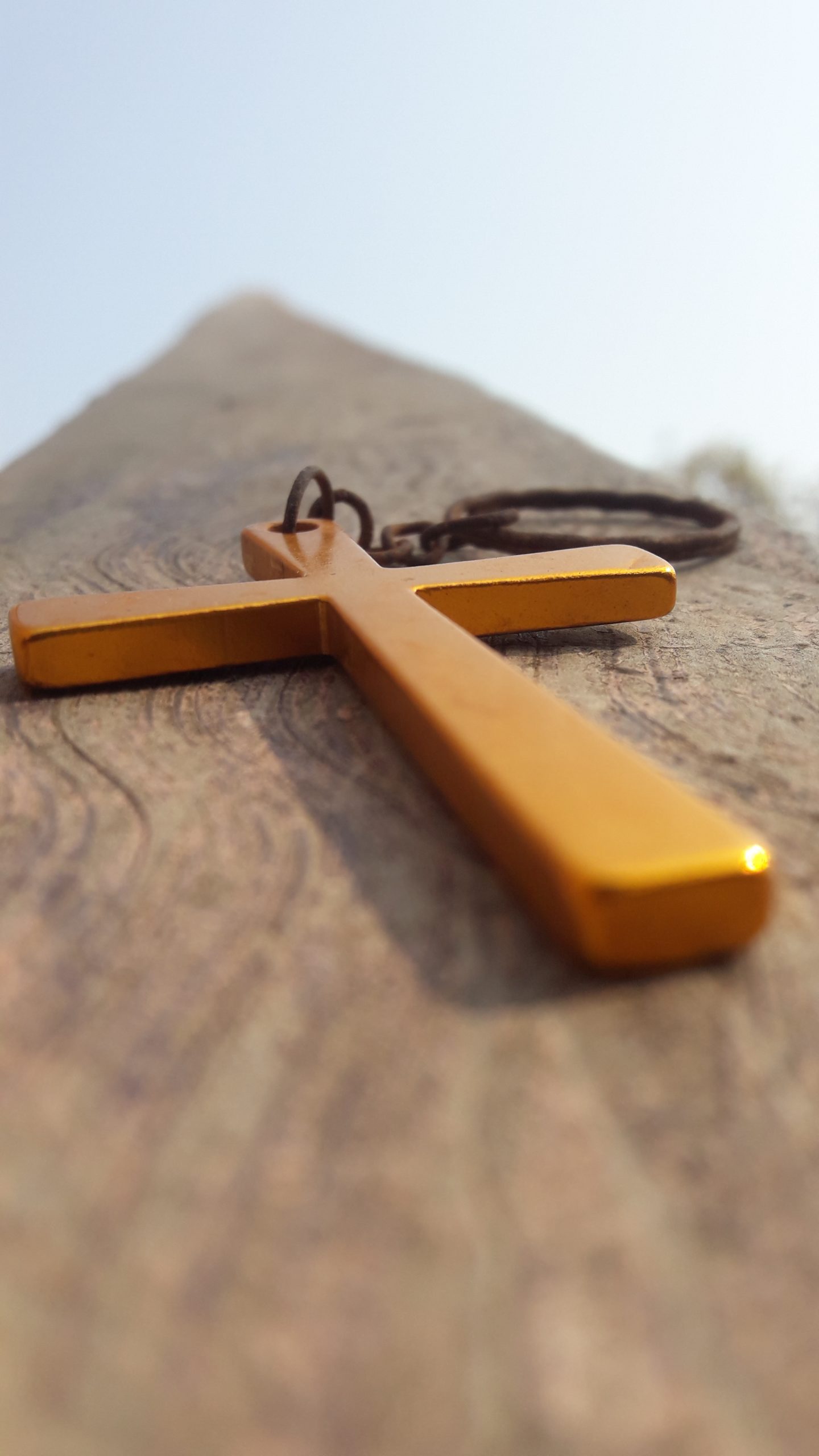 Cross sign key chain on the rock