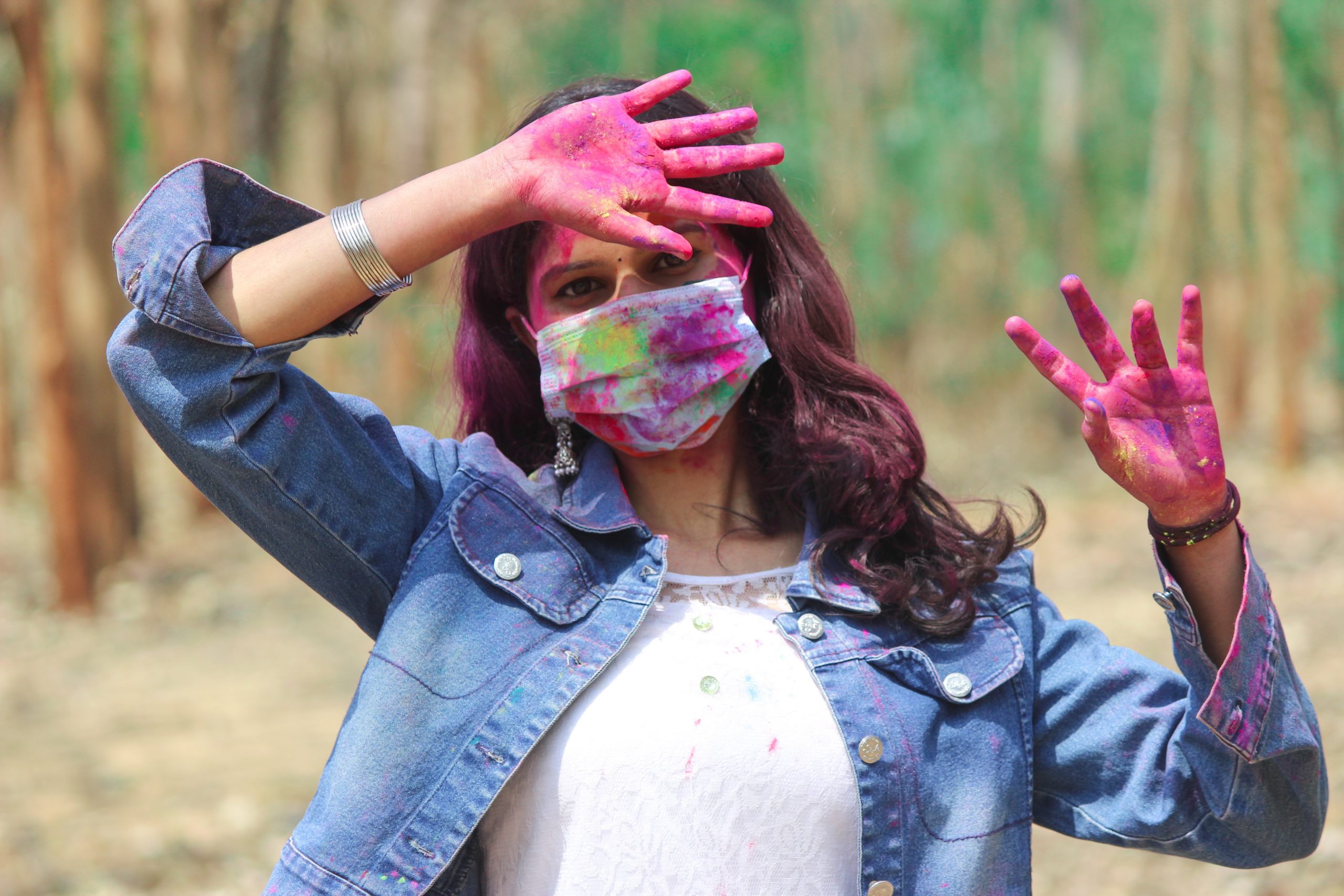 Girl playing Holi with mask