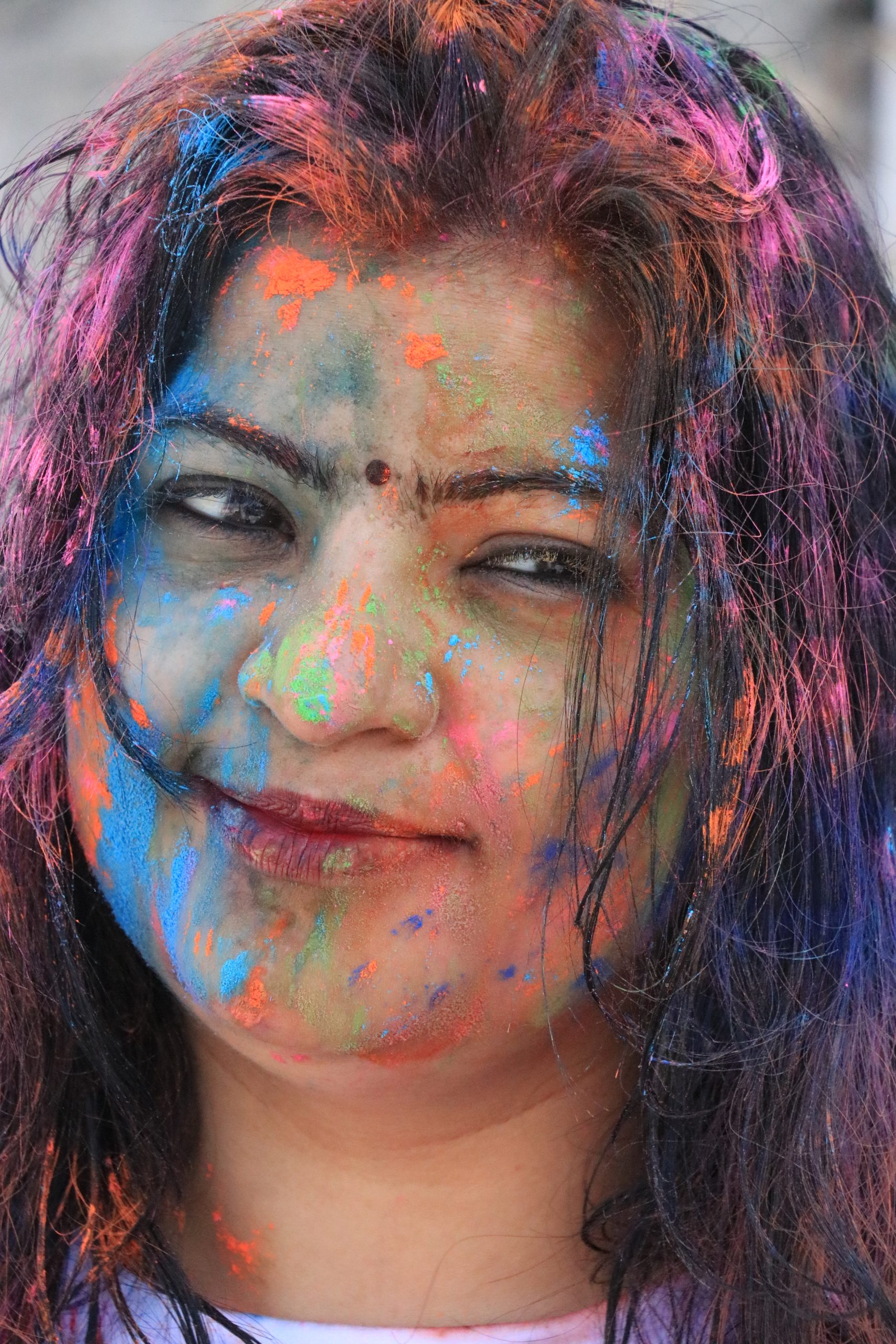 Girl posing with Holi colors on her face
