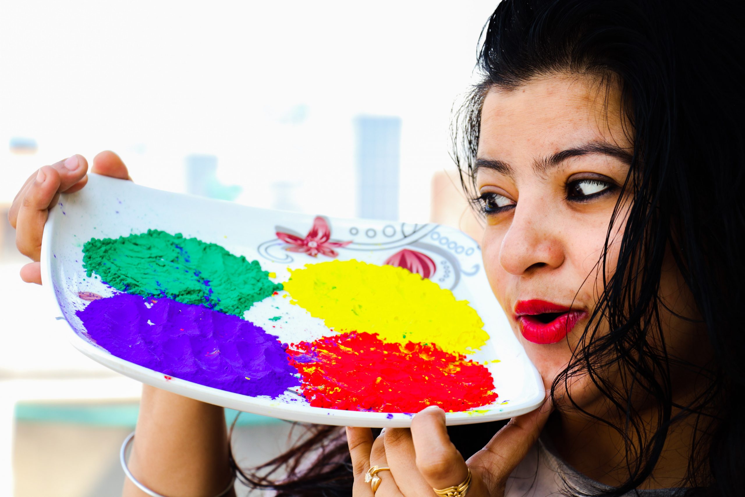 Girl with Holi colors in plate