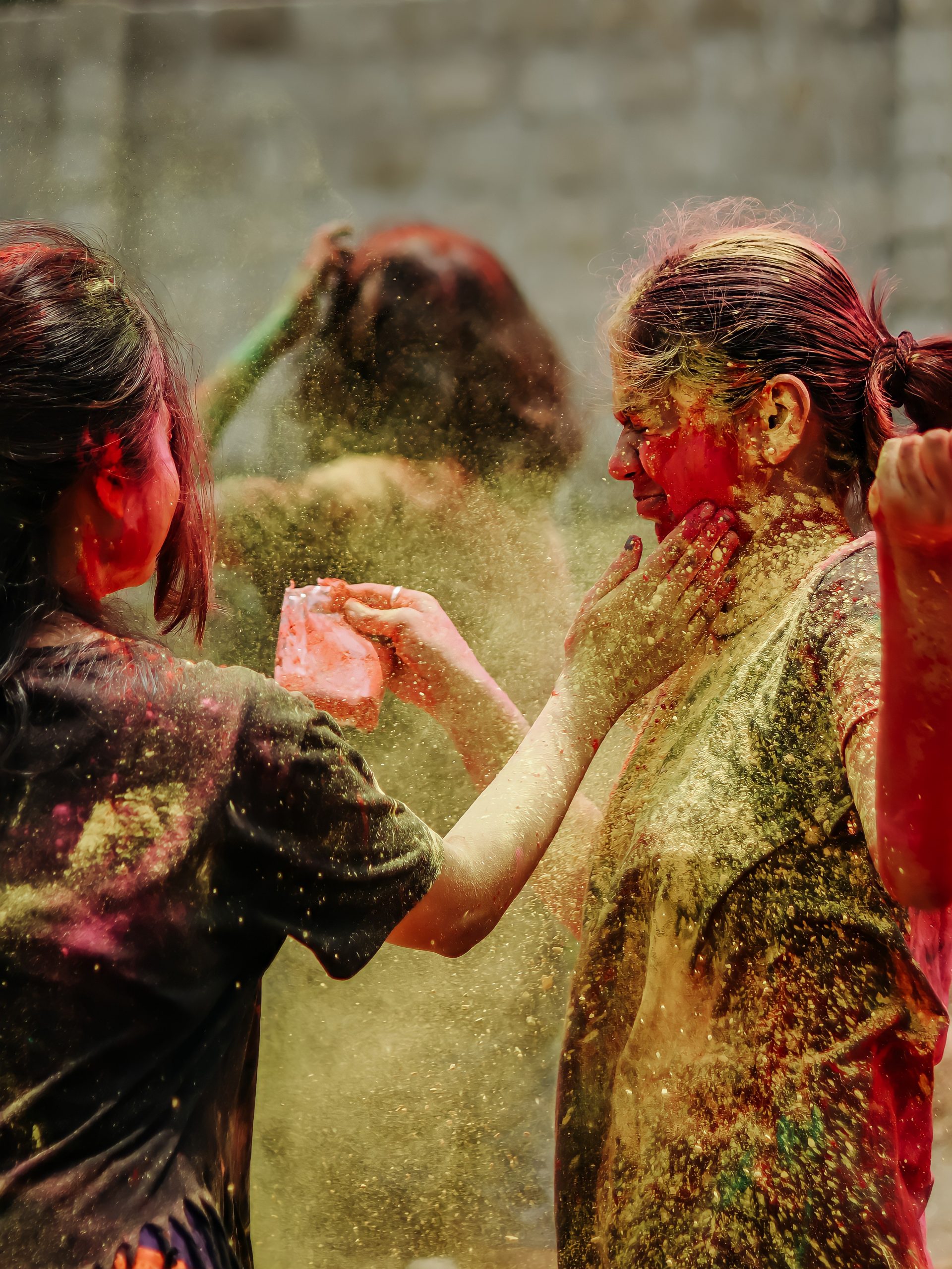 Girls playing with Holi colors