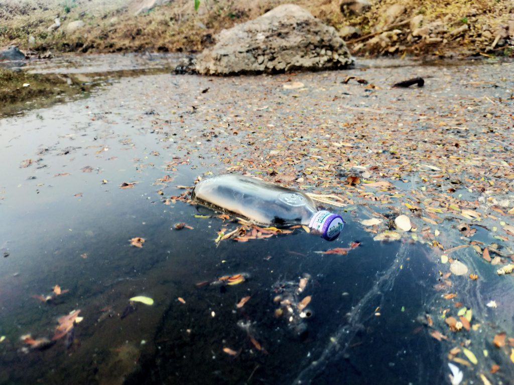 A glass bottle in dirty water PixaHive