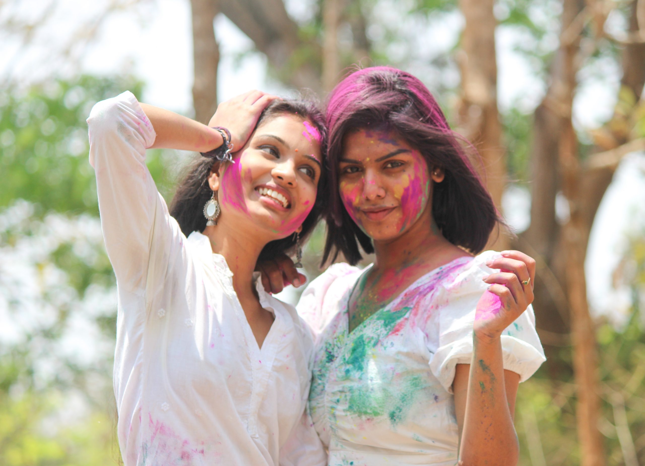 Girls posing with Holi colors