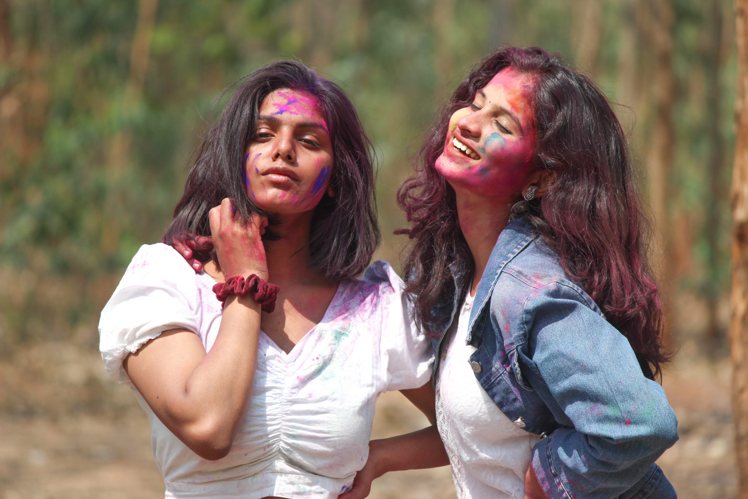 Happy girls playing with Holi colors